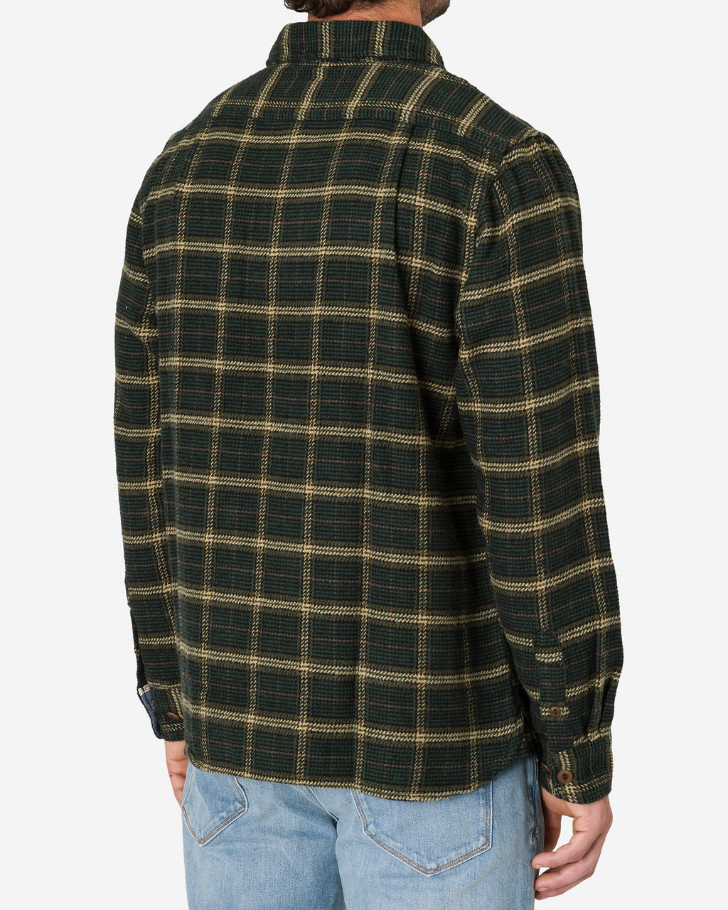 A man is shown from the back, wearing an Ace Rivington Flannel Utility Shirt - Forest Hound long sleeves, and light blue jeans. The shirt features a checkered pattern, and one of his hands is visible by his side on a plain white background.