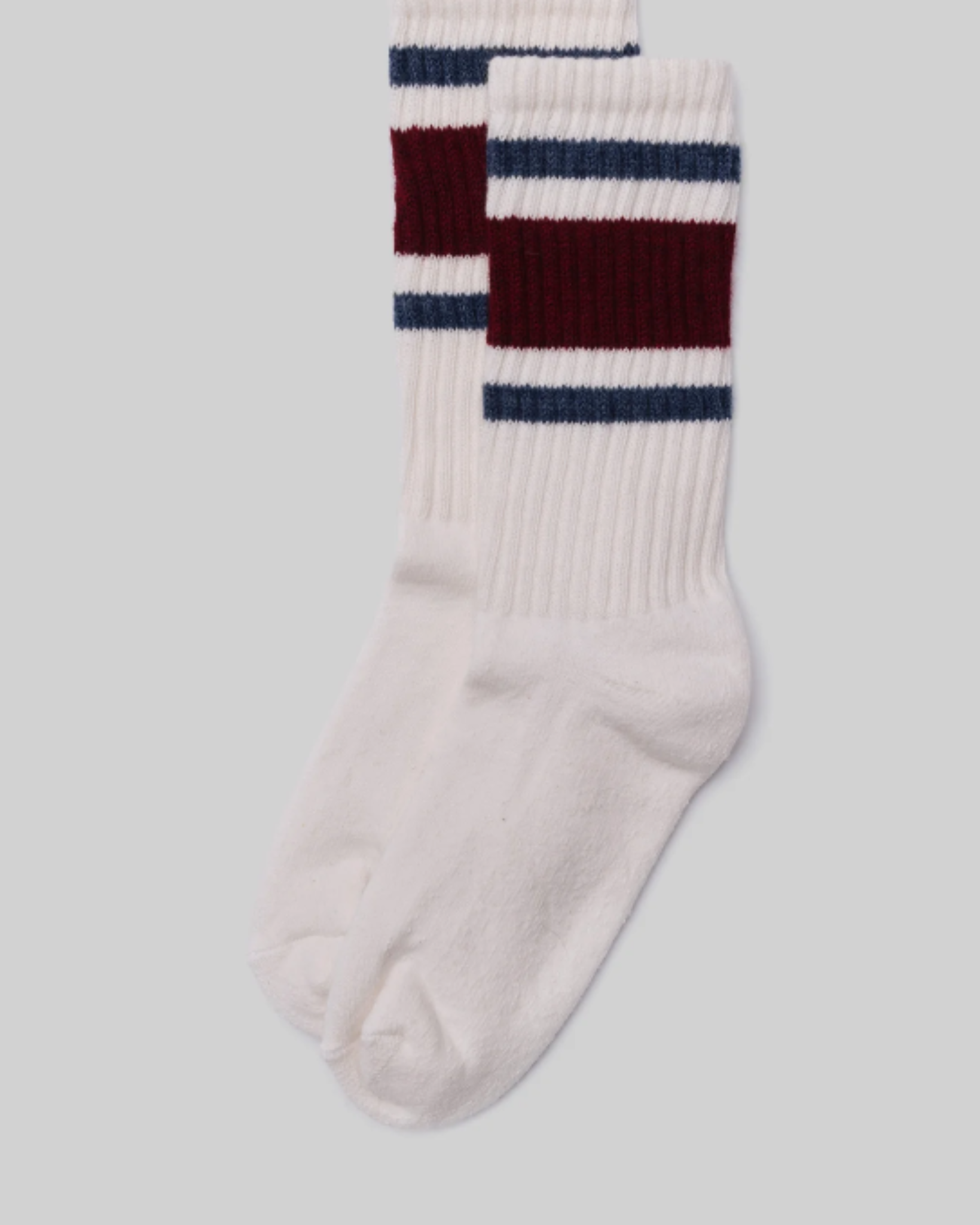 American Trench Retro Stripe Socks - Maroon, Navy, and White are laid flat, showcasing wide maroon and navy stripes near the cuff against a light grey background. This design evokes vintage athletic socks, adding a nostalgic and stylish touch.
