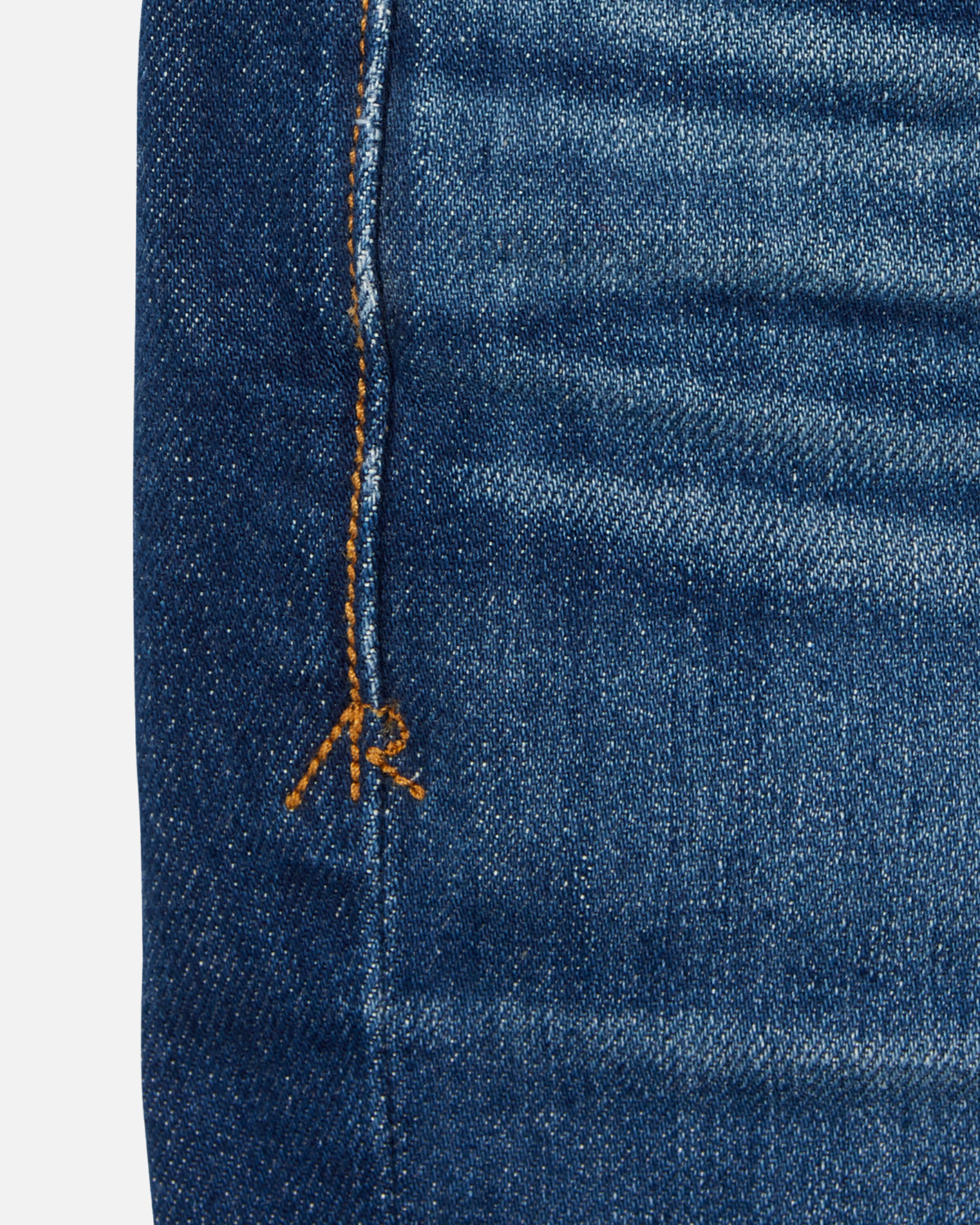 close up of stitching on dark blue vintage athletic taper jeans