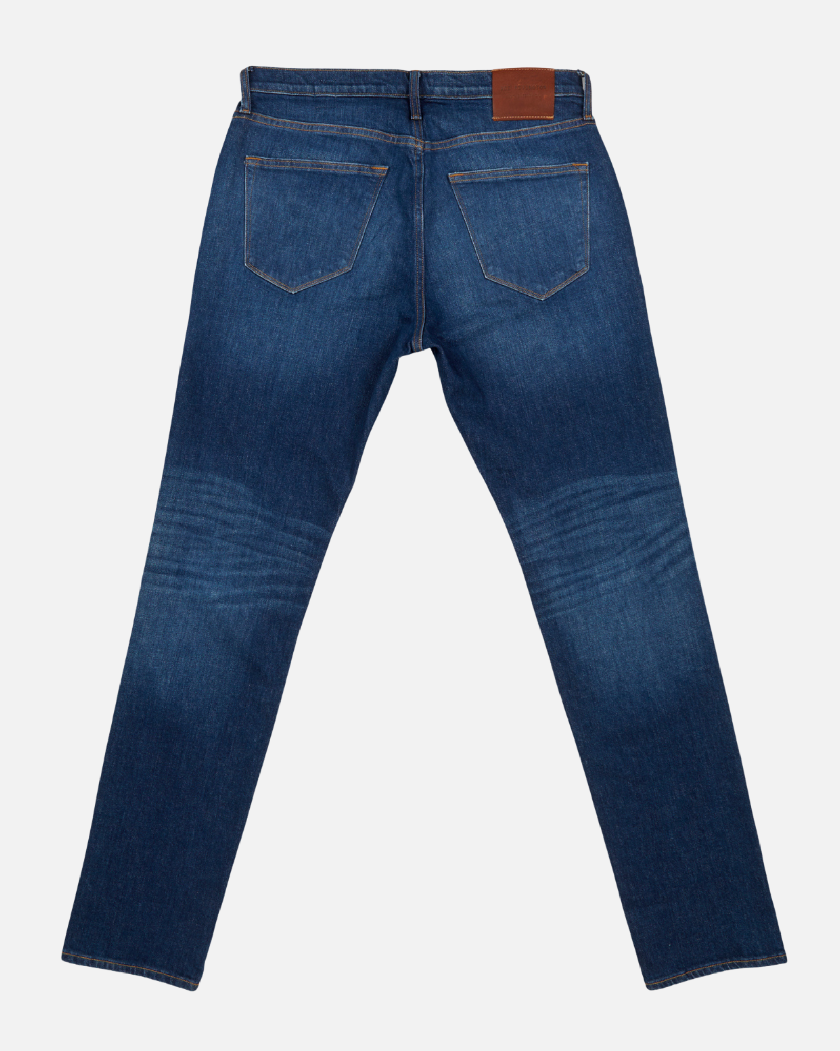back view of pair of dark blue vintage athletic taper jeans with fully extended legs