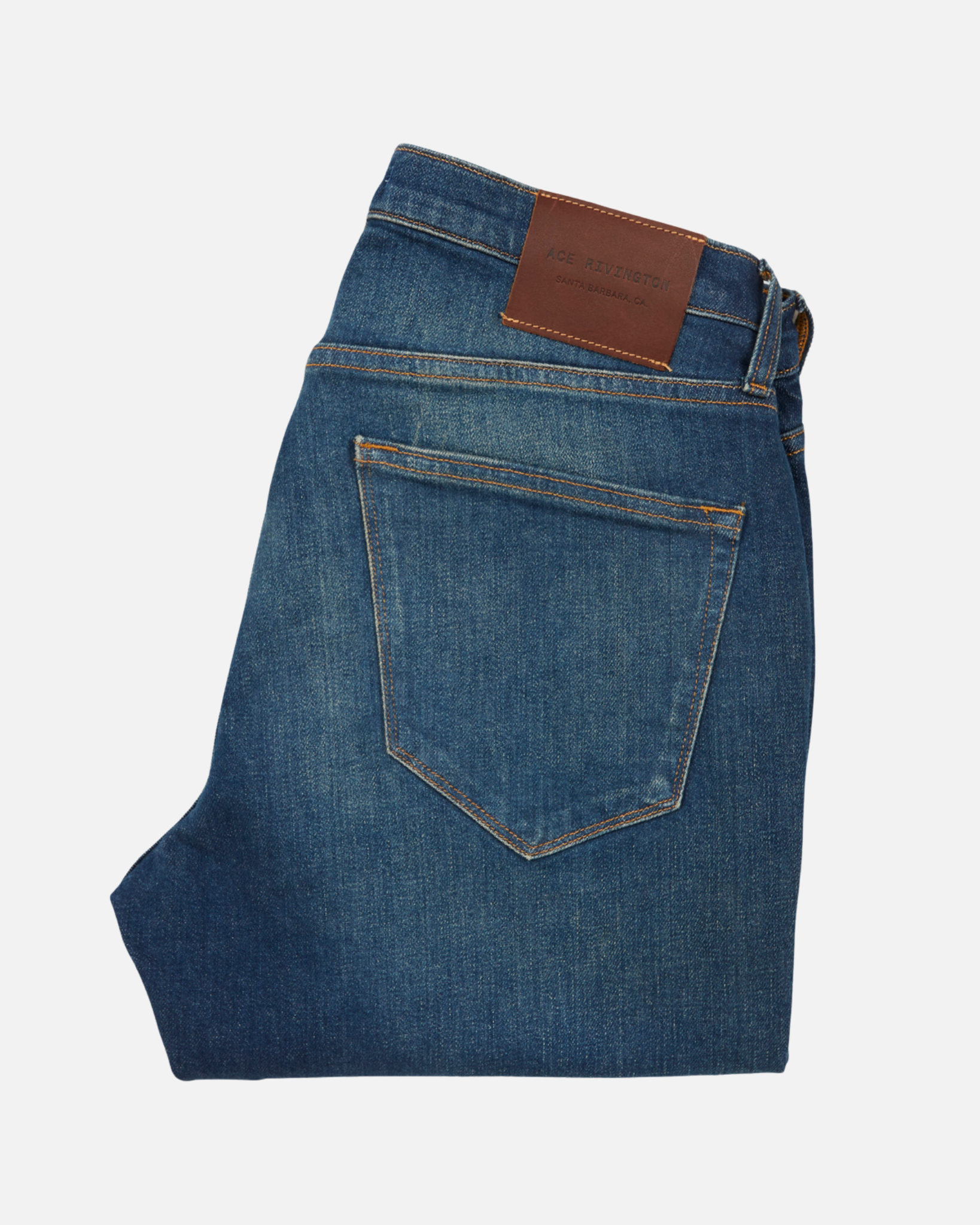 back of folded pair of men's athletic taper blue jeans with slight wear