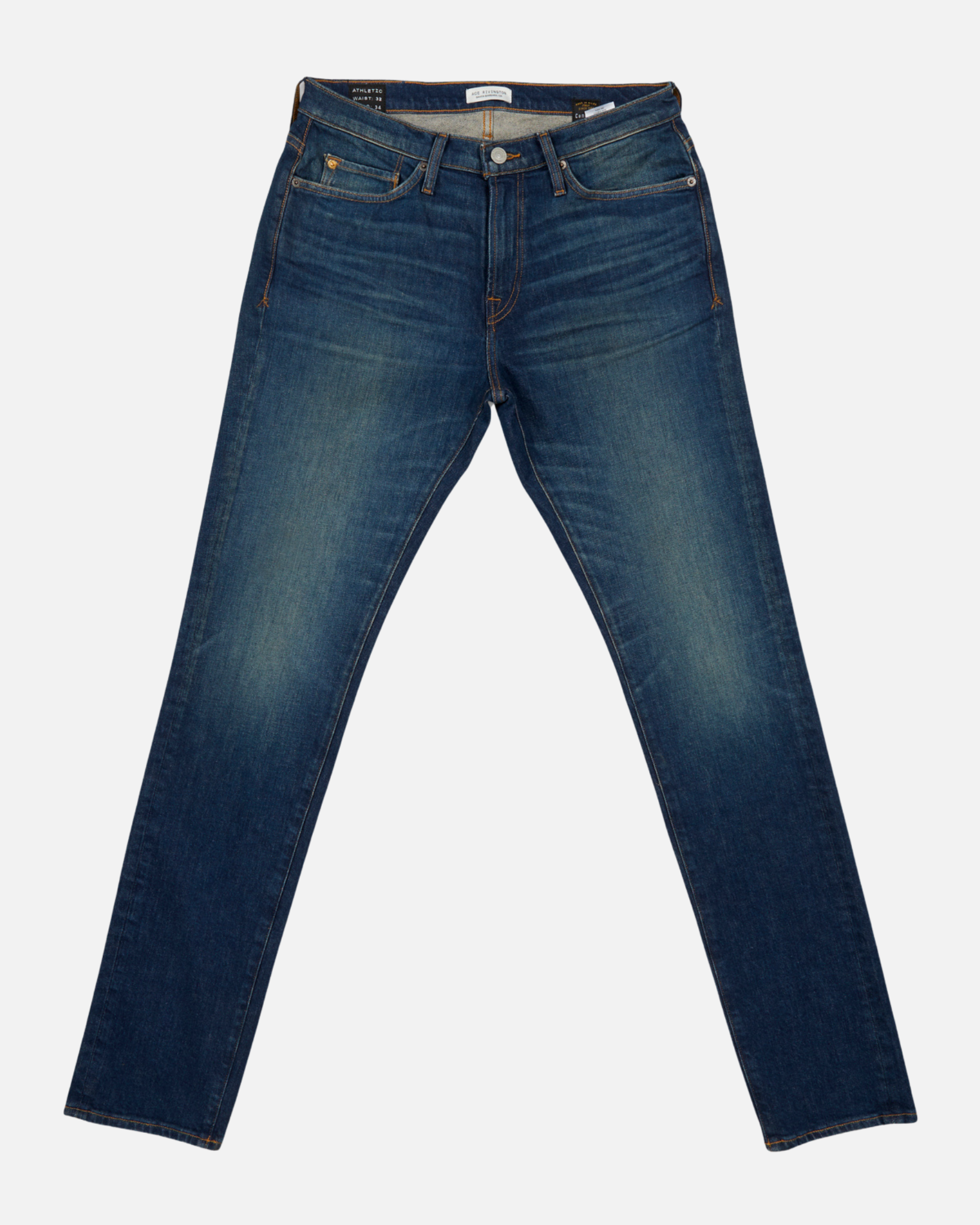fully extended pair of men's athletic taper blue jeans with slight wear