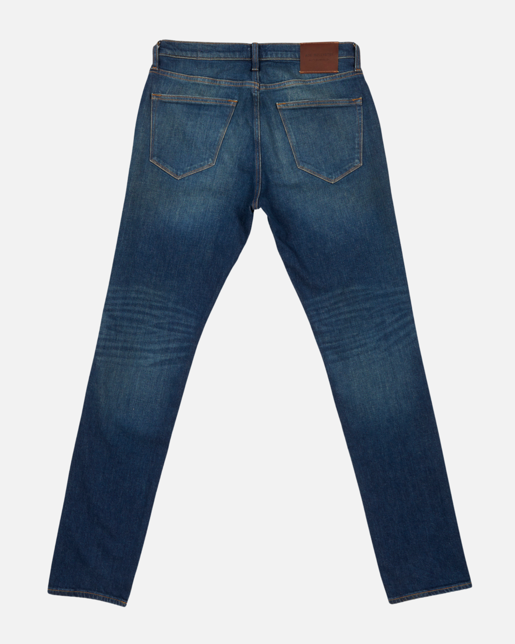 back of fully extended pair of men's athletic taper blue jeans with slight wear