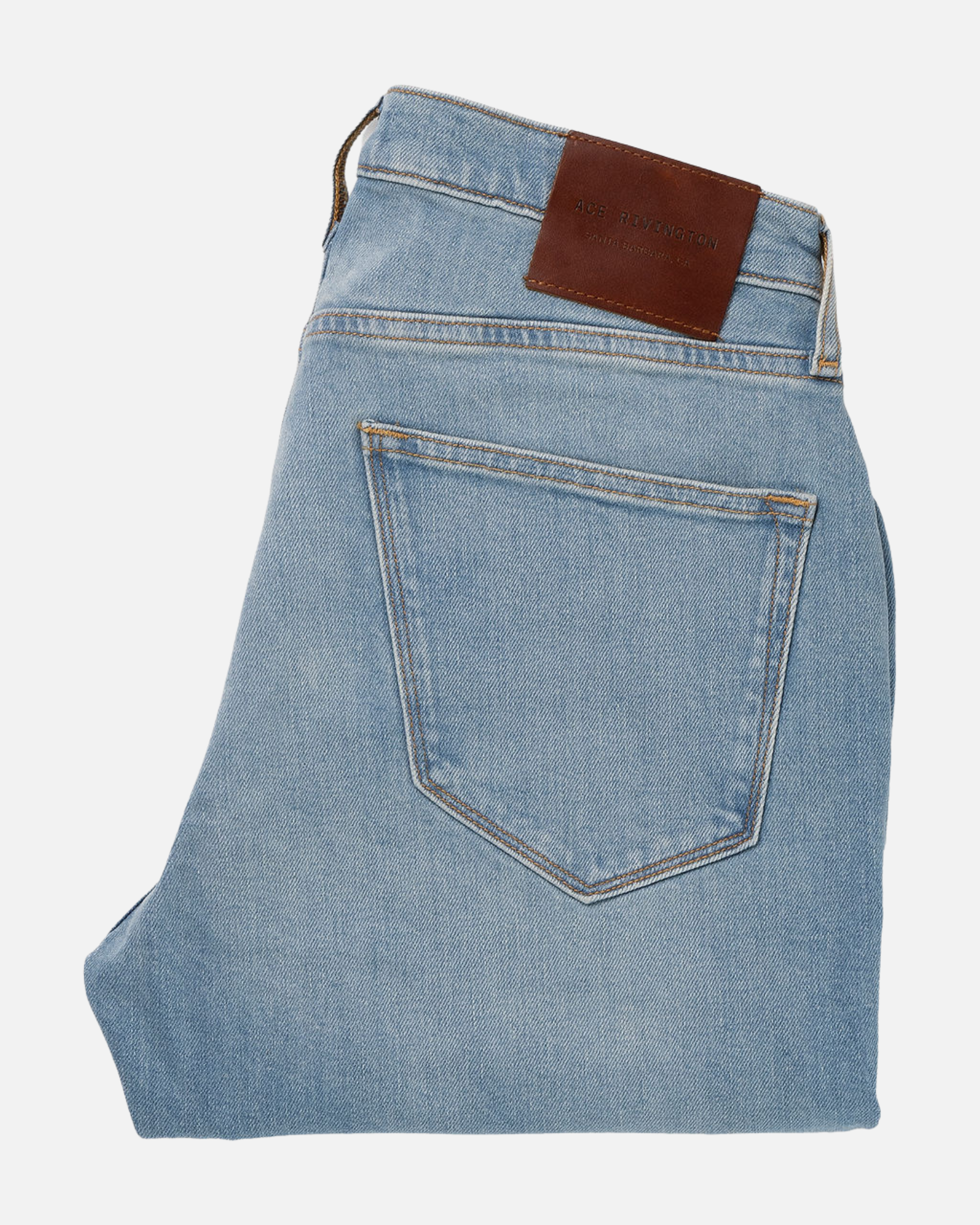 Folded pair of Athletic Taper Denim Jeans - Light Vintage with a visible back pocket and a brown leather patch on the waistband.