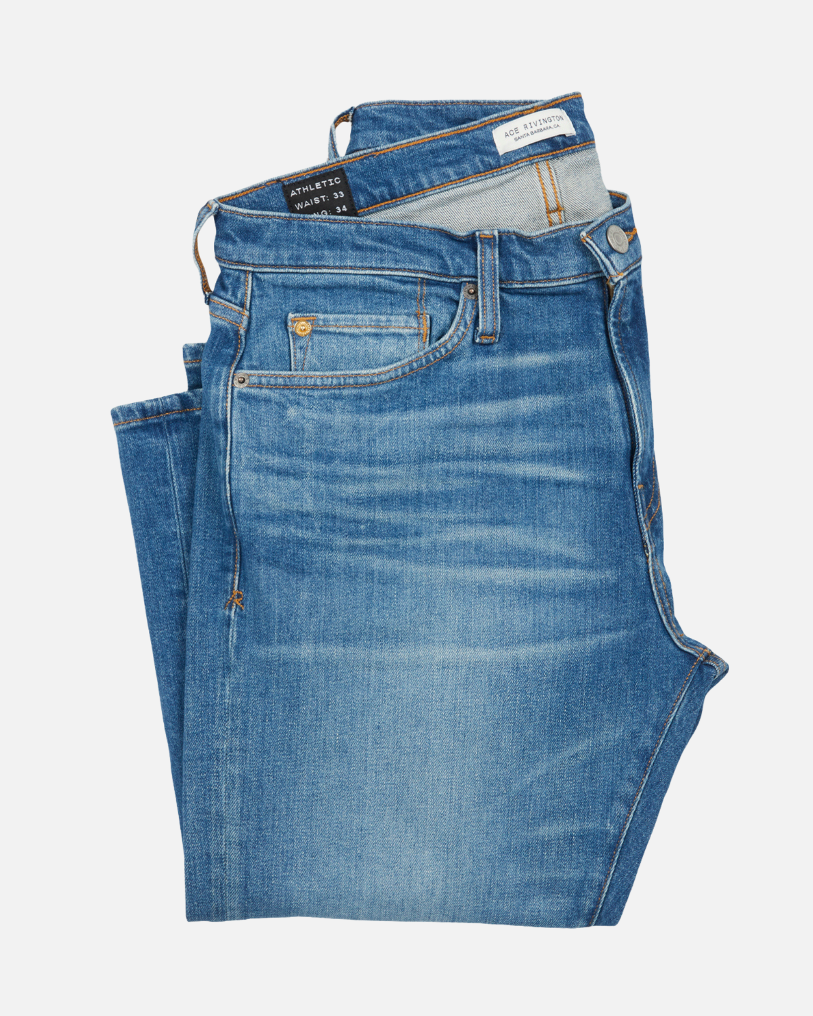 front of folded pair of men's athletic taper medium light blue jeans with slight wear