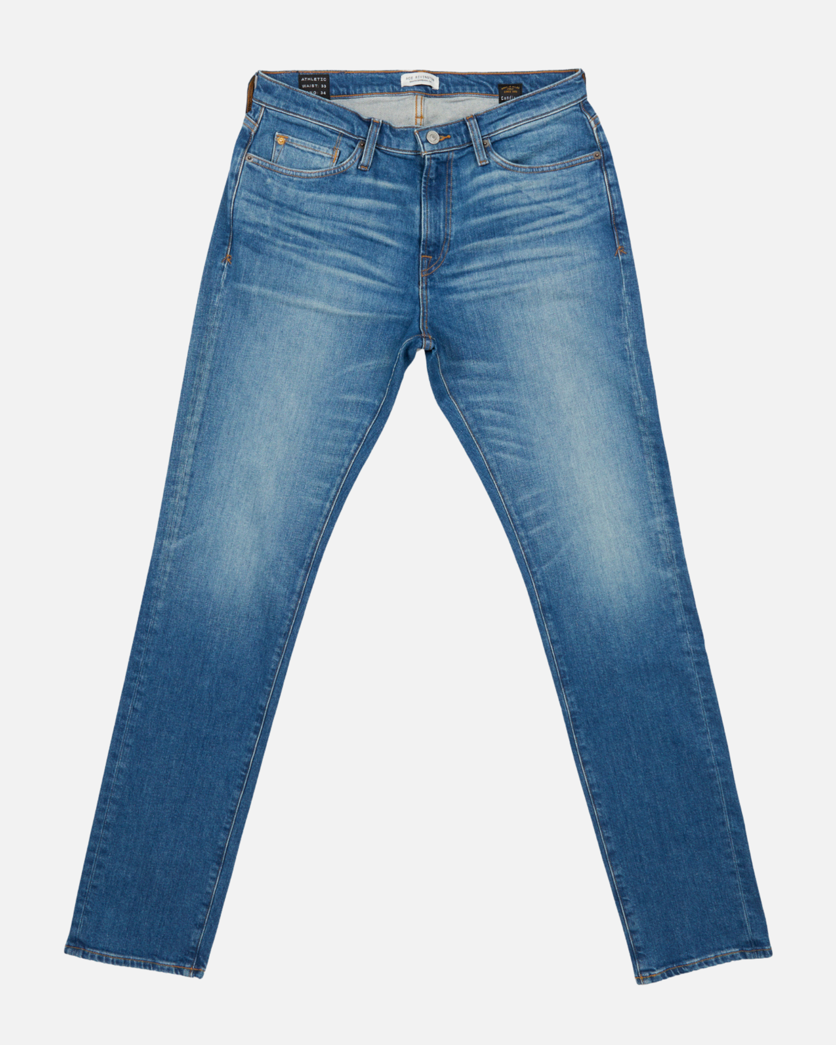 front of fully extended pair of men's athletic taper medium light blue jeans with slight wear