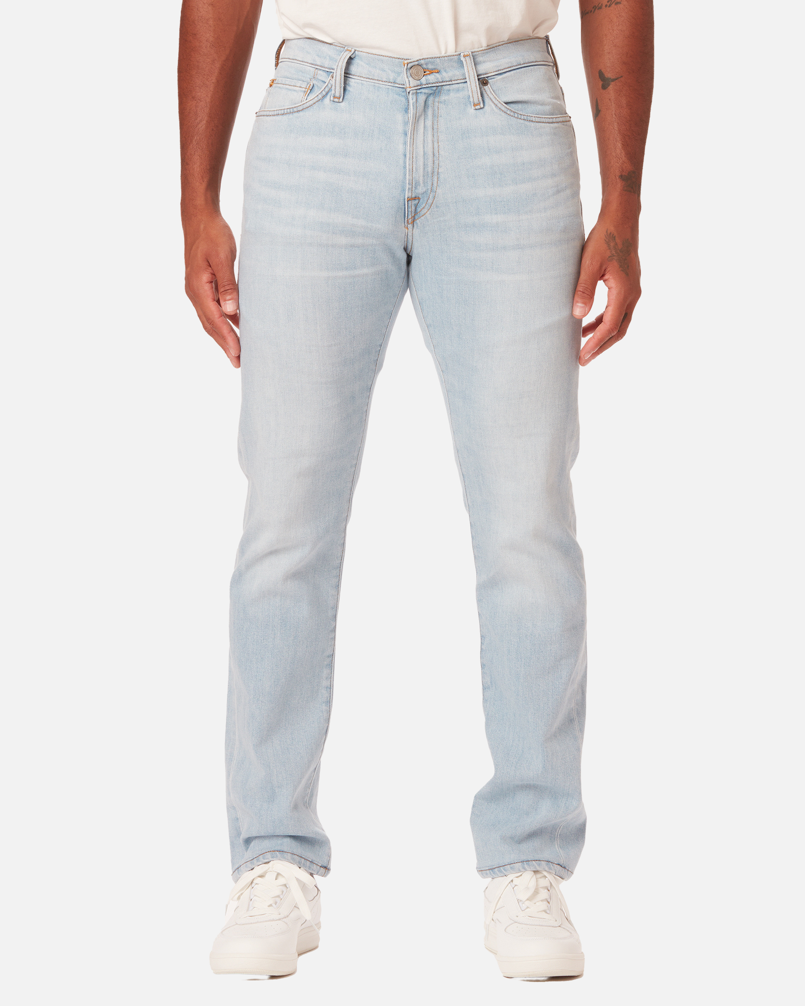 model facing directly forward wearing Ace Rivington super light blue denim jeans with antique nickel detailing with a pair of white Diadora B Elite sneaker shoes and tucked white Ace Rivington super soft supima short-sleeved tee shirt
