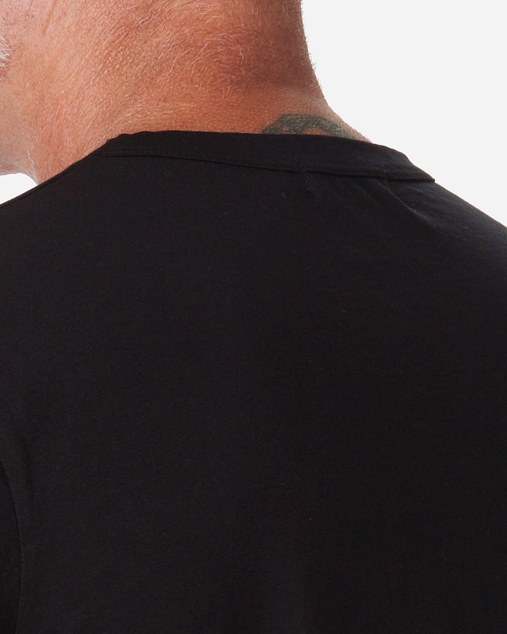 back of neck of model wearing Ace Rivington men's black t shirt made with super soft supima cotton