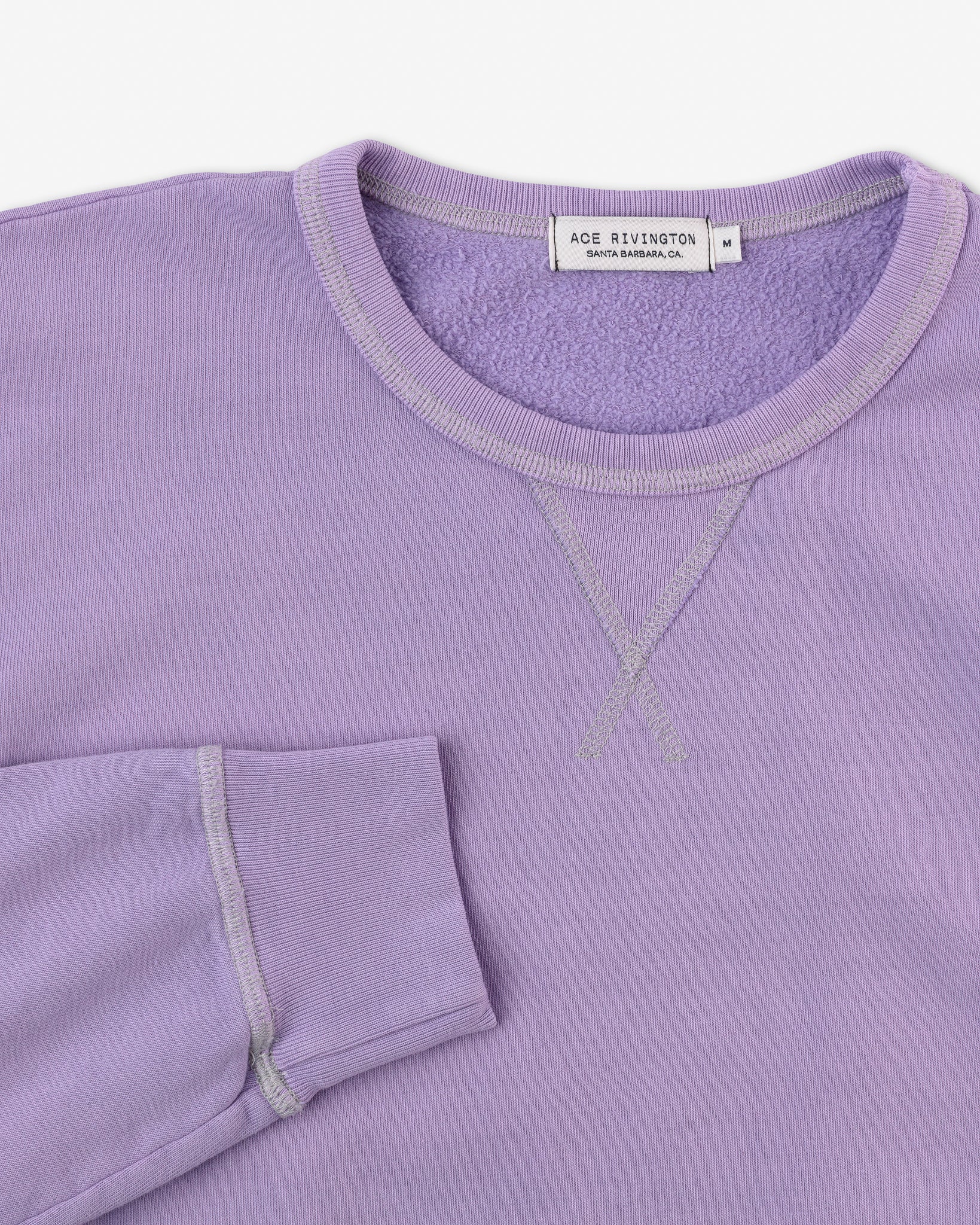 right sleeve set near collar of organic cotton sweatshirt in digital lavender