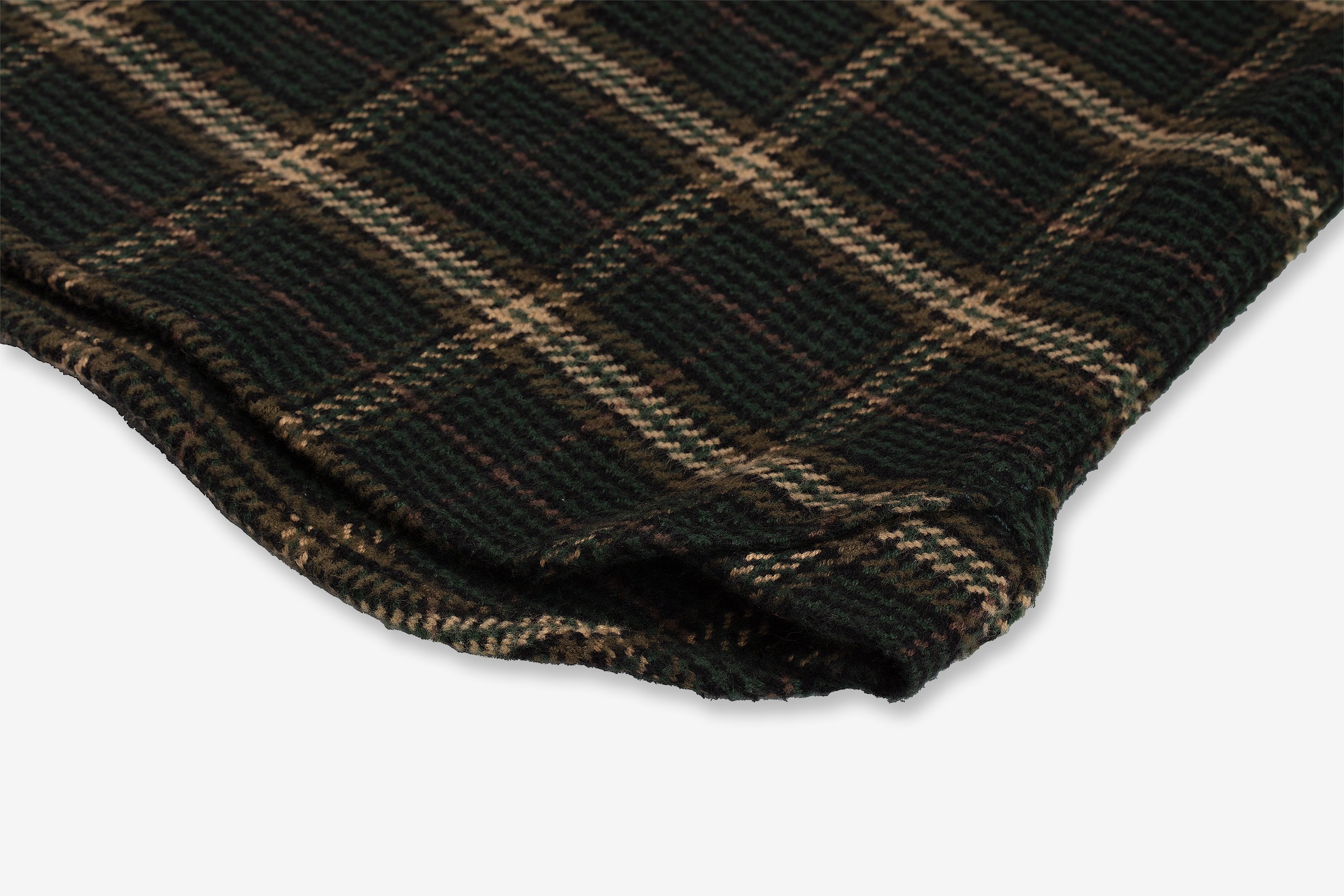 Close-up of the corner of Flannel - Utility Shirt - Forest Hound. The fabric has a textured surface, featuring intersecting lines that form squares showcasing the intricate plaid design by Ace Rivington.