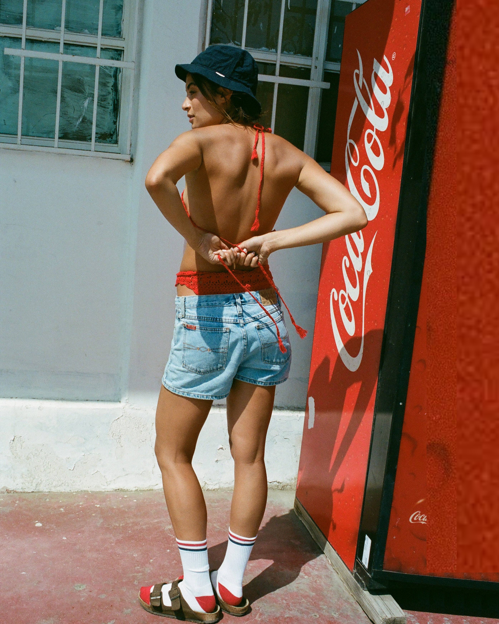 Kennedy Luxe Athletic Socks - White/Red/Navy worn mid-calf with red sandals and denim shorts in an outdoor setting beside a Coca-Cola vending machine.