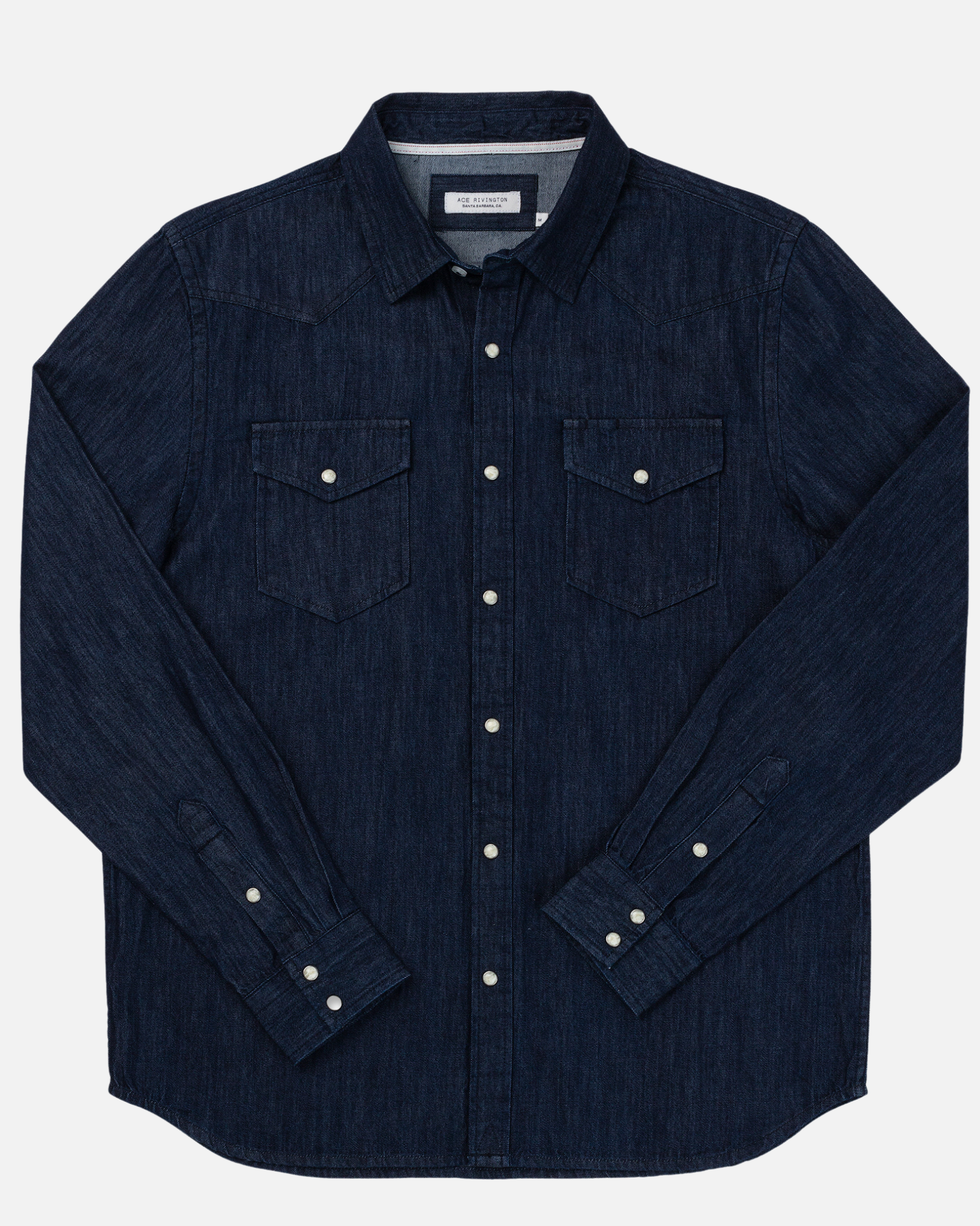 Ace Rivington's dark wash mid-weight denim western H1 long-sleeve shirt features a classic collar, silver snap buttons down the front, and two chest pockets with flap closures. The fabric has a mid-weight texture, suitable for casual or semi-casual wear.