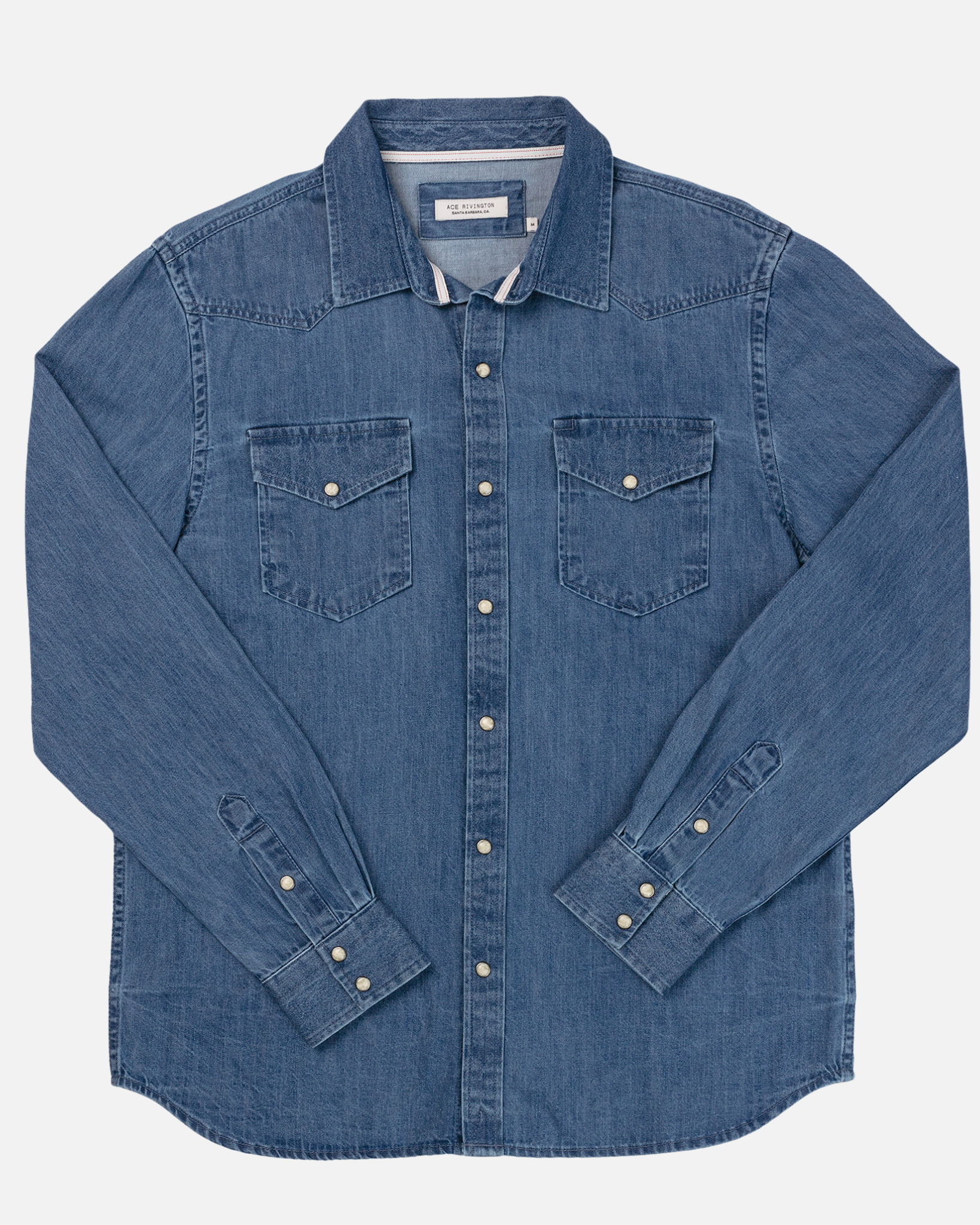 A medium-wash denim western shirt by Ace Rivington features a classic design with a button-down front, two chest pockets with button flaps, and long sleeves with buttoned cuffs. The denim fabric has a mid-weight feel, making it suitable for various occasions.