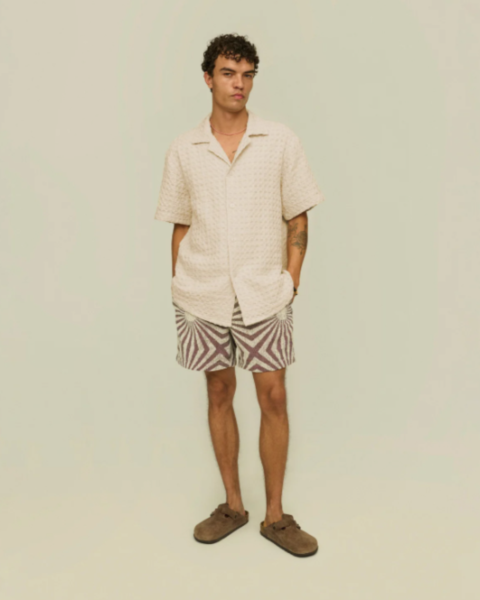 OAS Waffle - Cuba Shirt - Ecru worn by a male model facing forward, styled with patterned shorts and suede shoes, emphasizing a relaxed, summer-ready outfit.