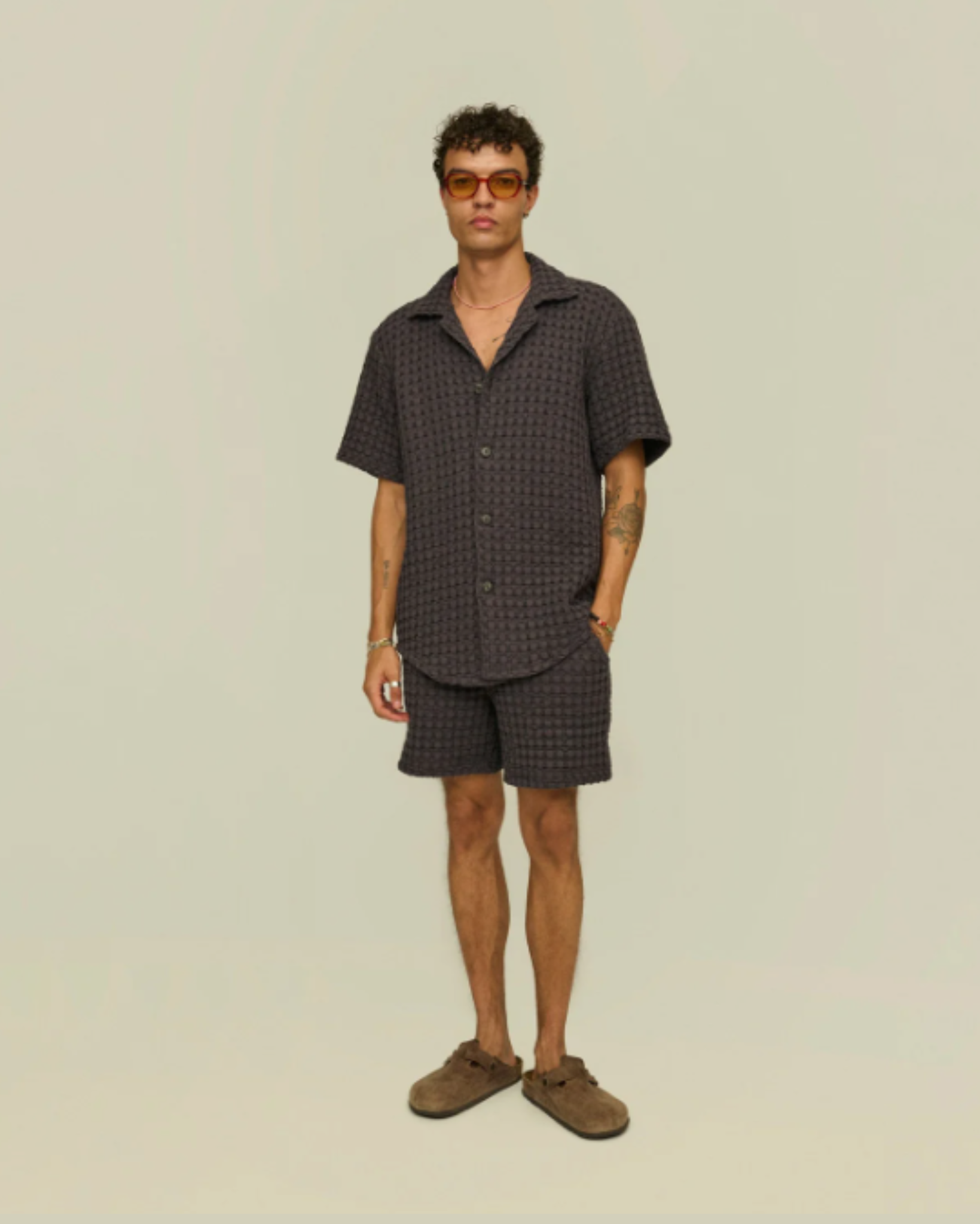 OAS Waffle - Cuba Shirt - Nearly Black full-body view of the model wearing the shirt and coordinating shorts, paired with brown shoes and orange sunglasses for a cohesive summer look.
