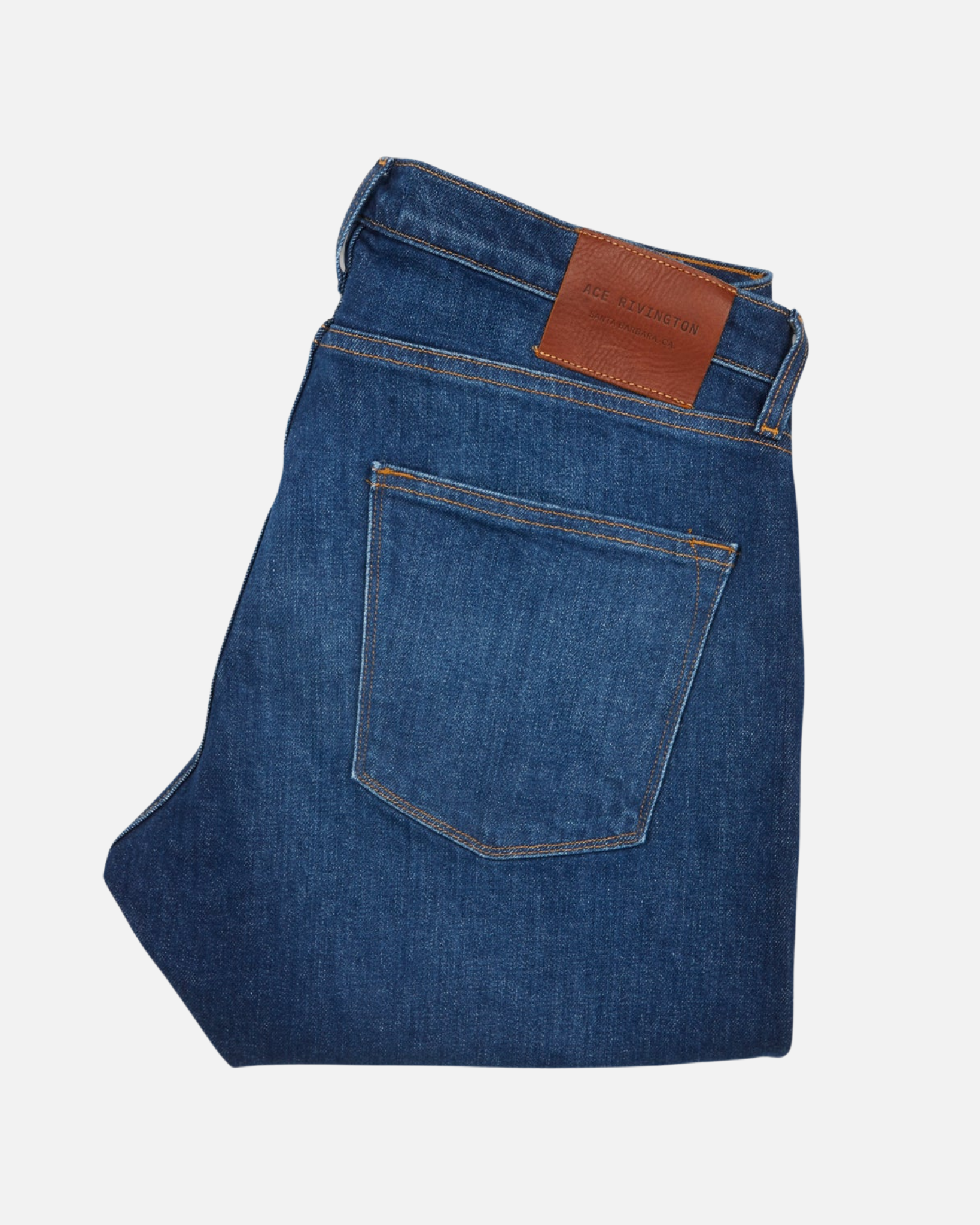 back of folded pair of high quality slim cut men's dark blue jeans with slight wear