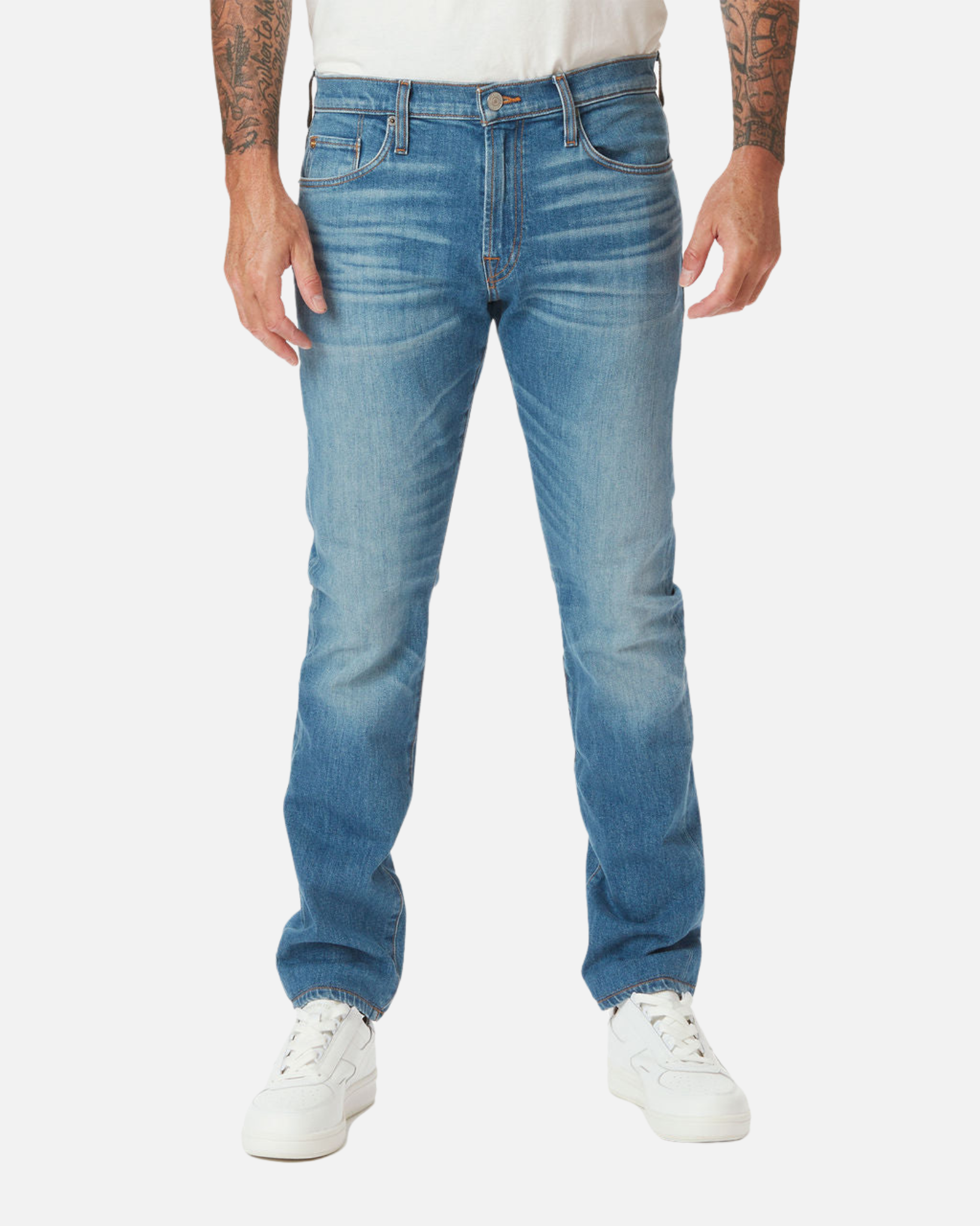 Front of model facing directly forward wearing Ace Rivington medium slim tapered light blue denim jeans with light wear along the thighs with a pair of white Diadora B Elite sneaker shoes and tucked white Ace Rivington super soft supima short-sleeved tee shirt