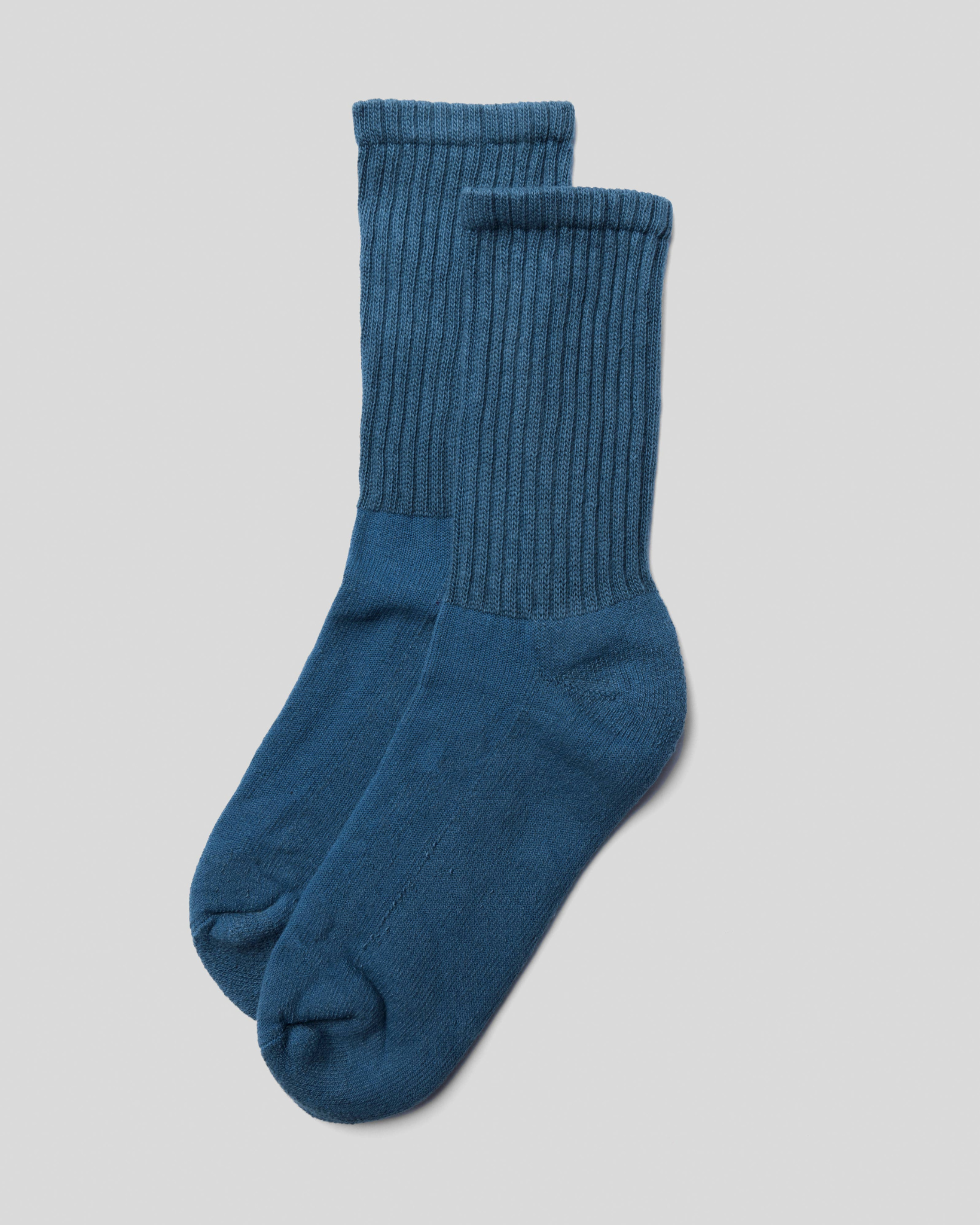 The Solids - Blue in a top-down view with ribbed structure and rich blue color on a light grey background.