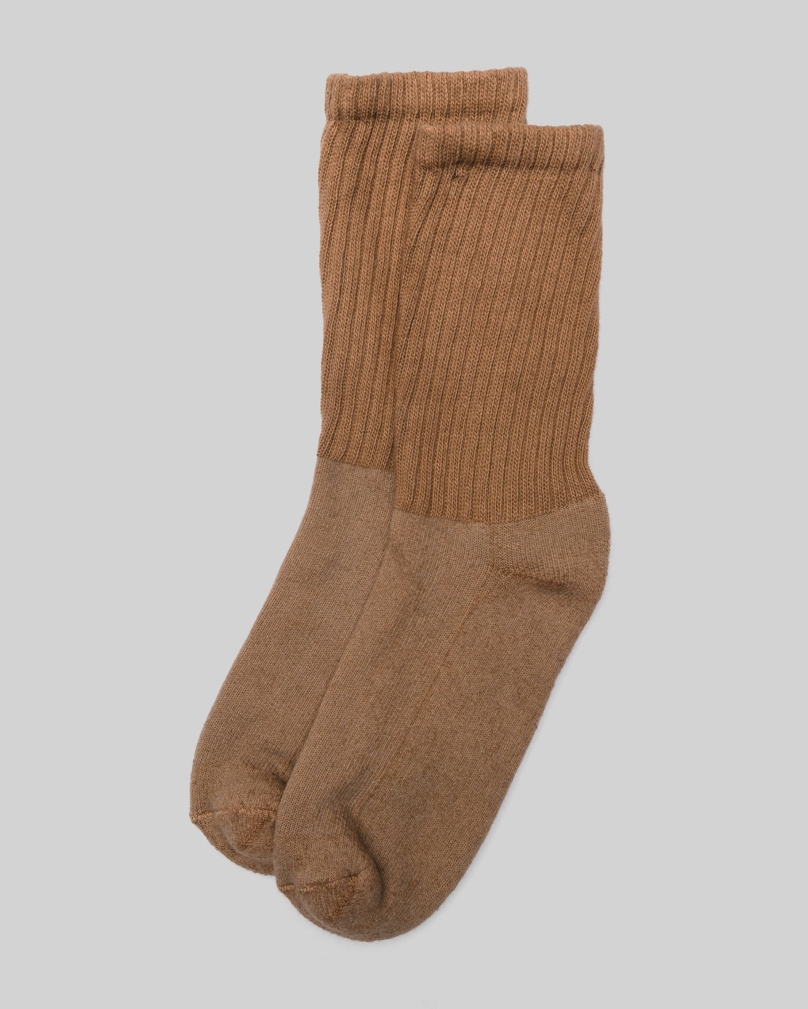 The Solids - Brown in a top-down view with ribbed texture and rich brown tone on a light grey background.