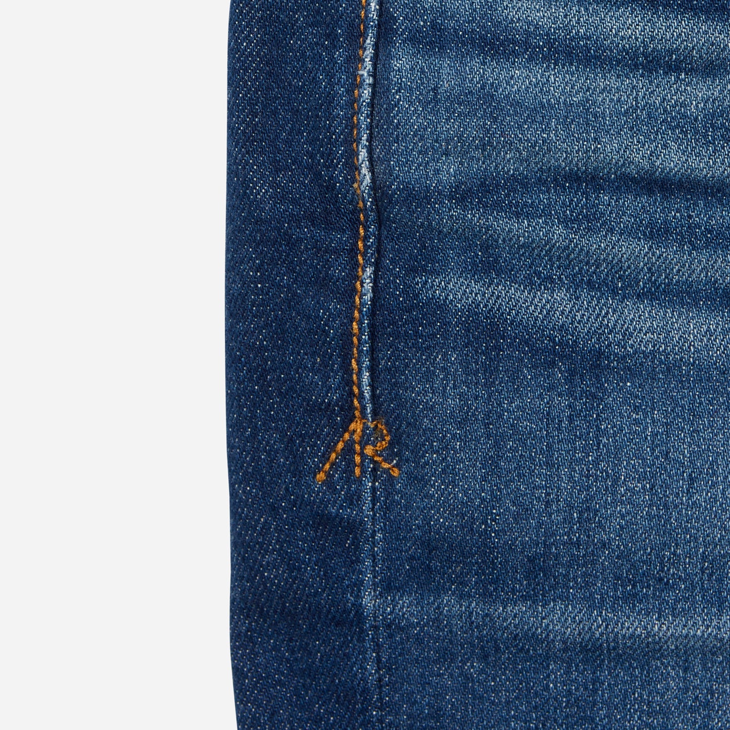 close up of stitching on dark blue vintage athletic taper jeans
