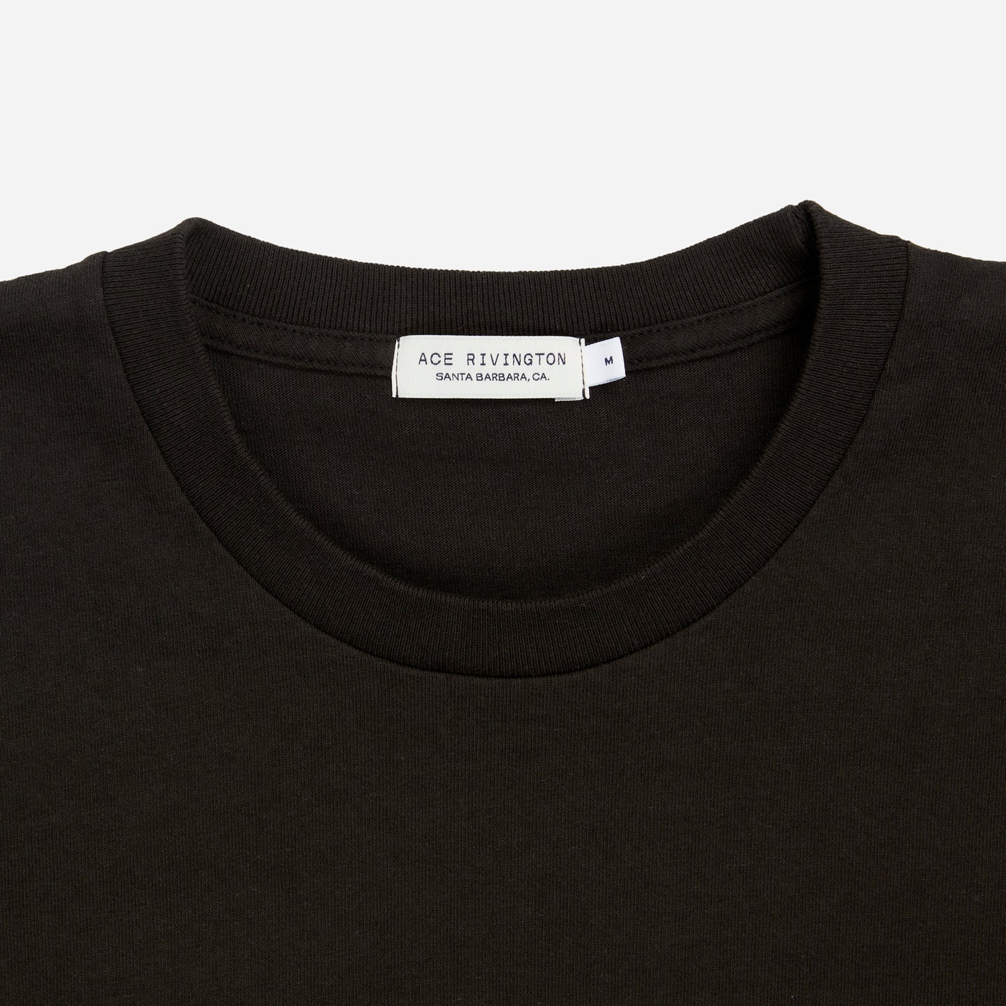 zoomed in view of plain black men's t shirt with Ace Rivington brand logo in medium