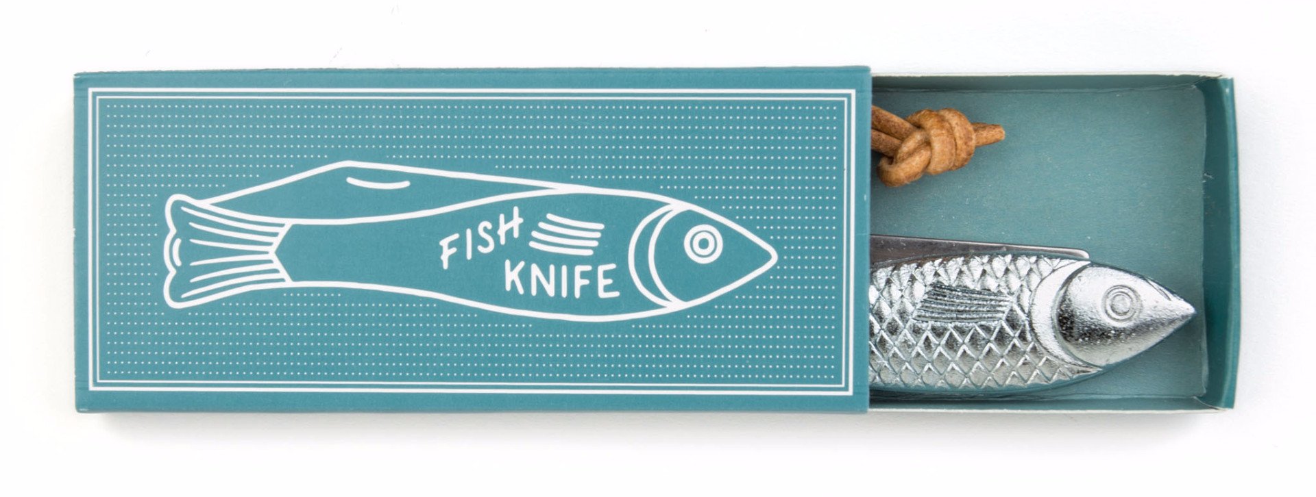 A teal-colored box with a white illustration of a fish and the words 'FISH KNIFE' on the lid. The box is partially open, revealing a metallic fish-shaped knife with a textured body and a rope loop at the end.