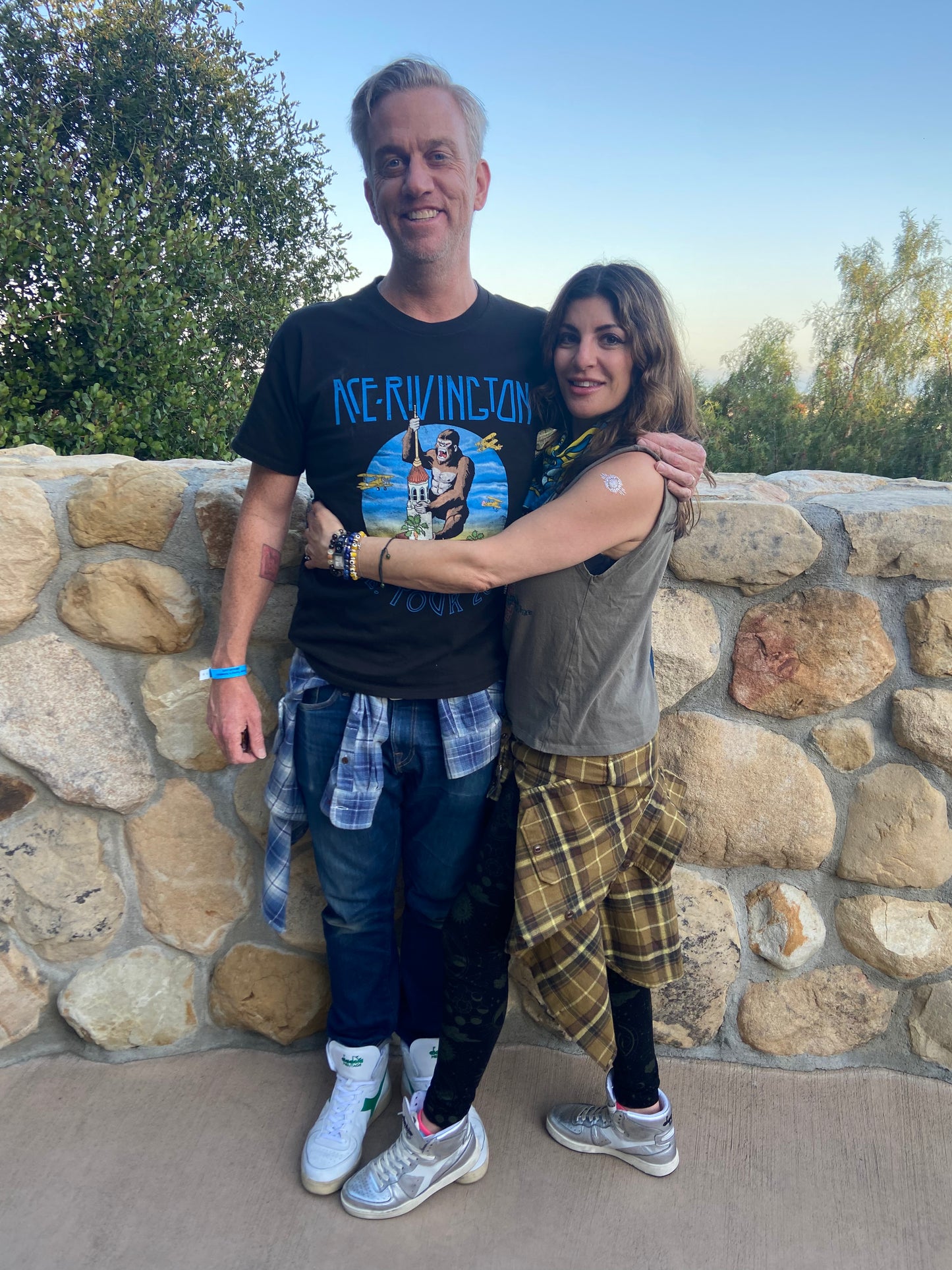 model C.E.Beau Lawrence wears Ace Rivington Tour 2022 men's black t shirt and poses with his wife Yasmin