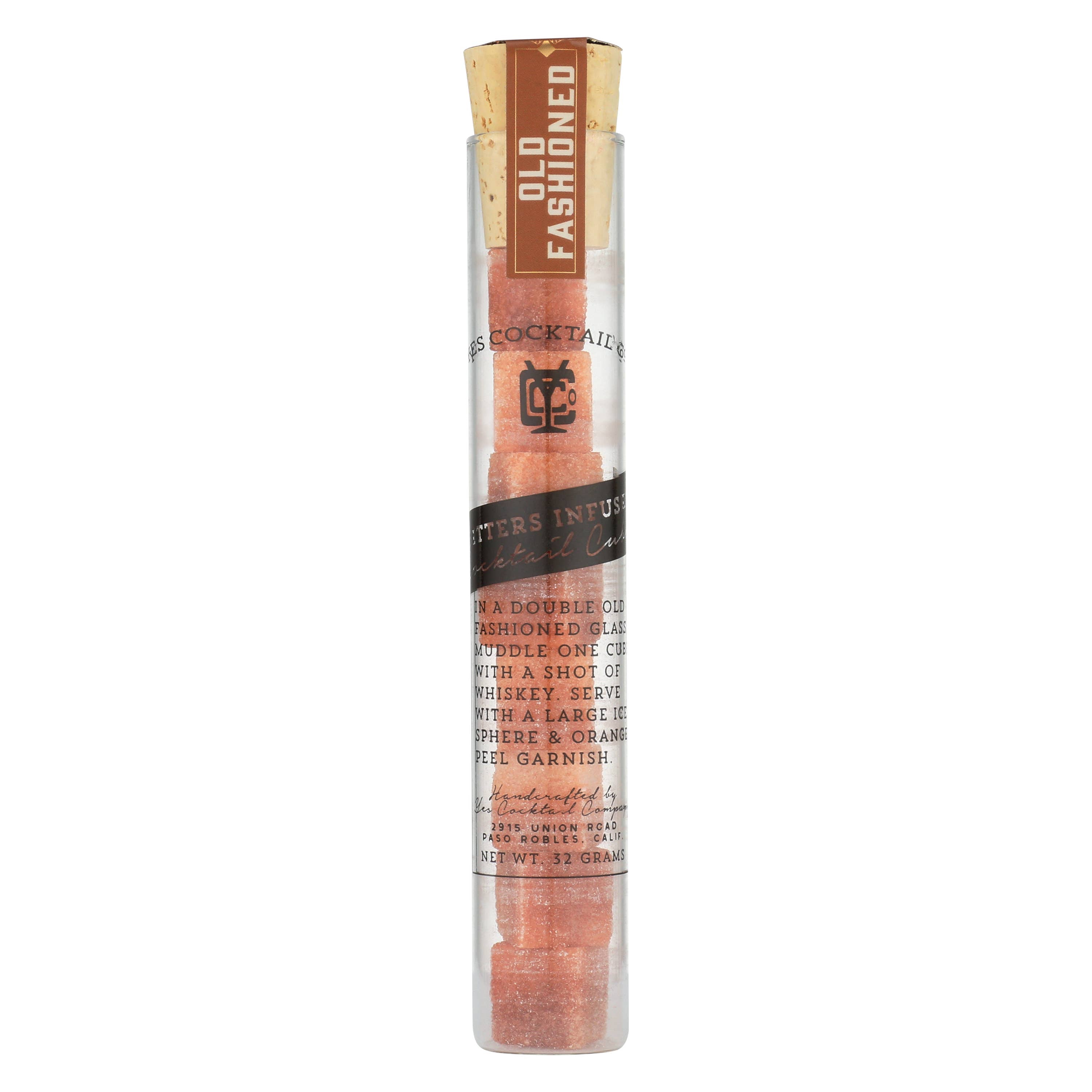 A clear cylindrical tube containing Ace Rivington Old Fashioned Bitters Infused Cocktail Cubes. The tube has a cork stopper and a label that reads 'OLD FASHIONED' at the top. The label also includes instructions for making an Old Fashioned cocktail by muddling one cube with a shot of whiskey, stirring with a large ice sphere, and garnishing with an orange peel. The net weight is 3.7 grams.