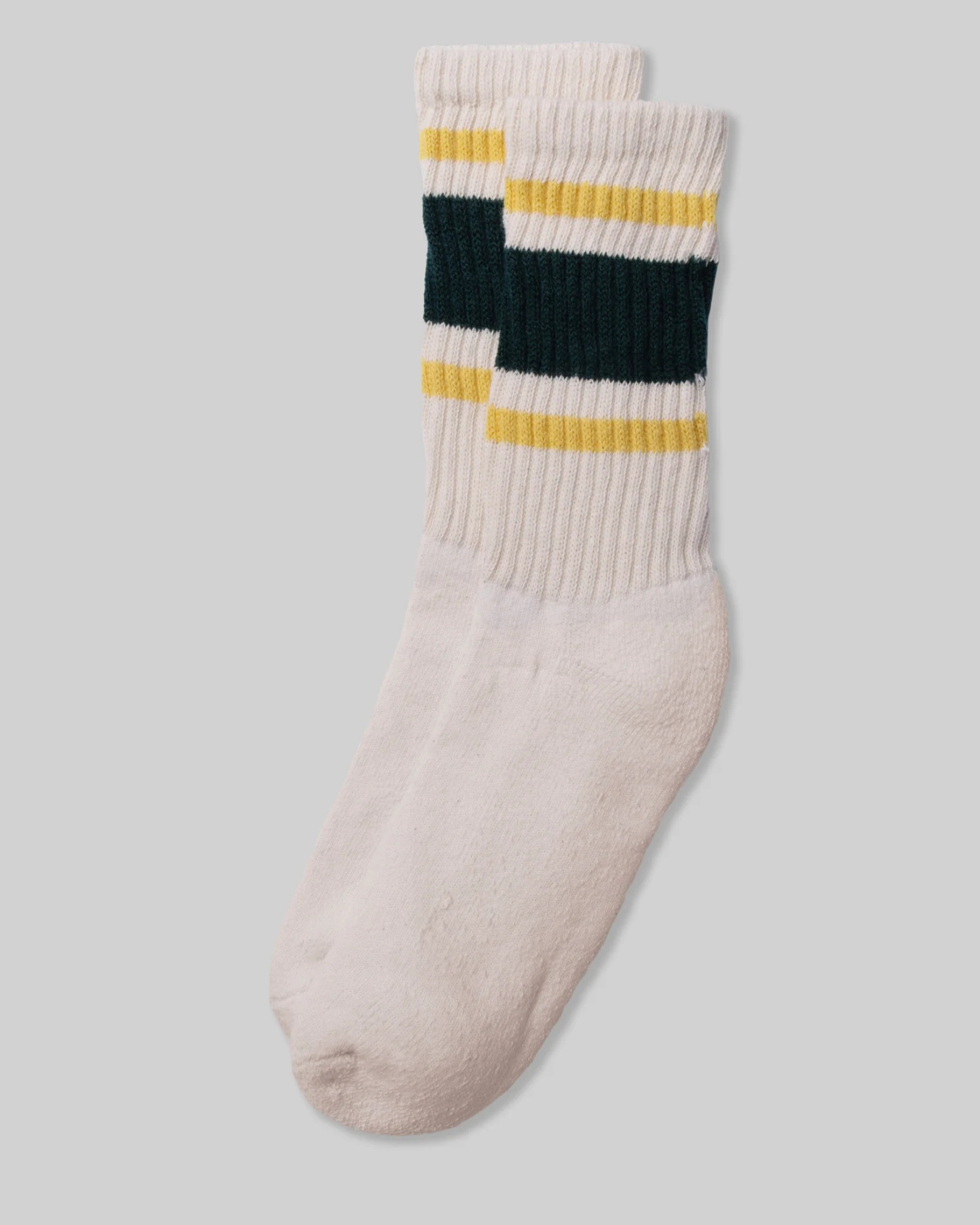 American Trench Retro Stripe Socks - Gold, Green, and White shown in a flat lay with thick green and gold stripes on a light grey background. The design is reminiscent of vintage athletic socks, adding a nostalgic and stylish touch.