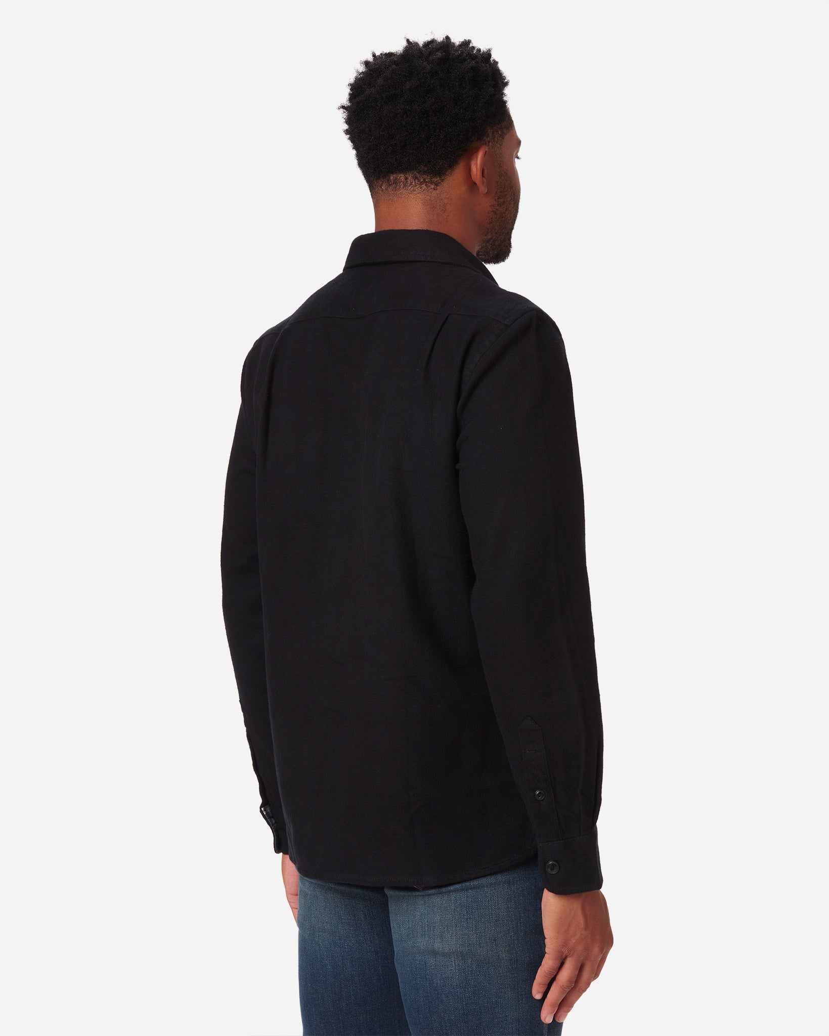 back of model with a rightward gaze wearing Ace Rivington men's black soft brushed flannel shirt 