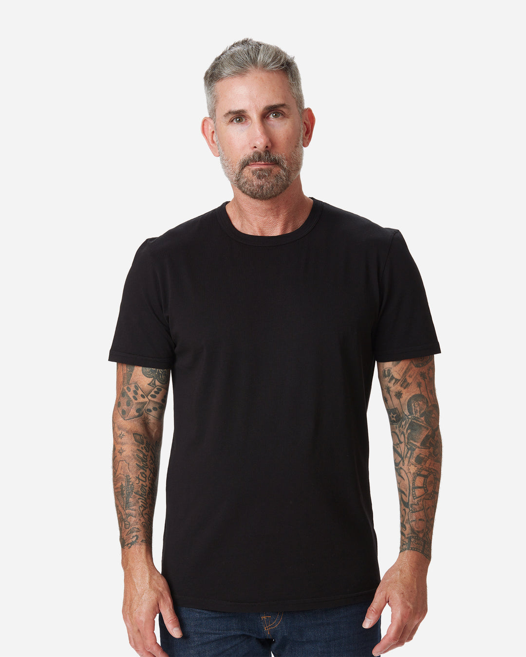model facing directly forward wearing Ace Rivington men's black t shirt made with super soft supima cotton and pair of Ace Rivington dark clean deep indigo blue denim jeans