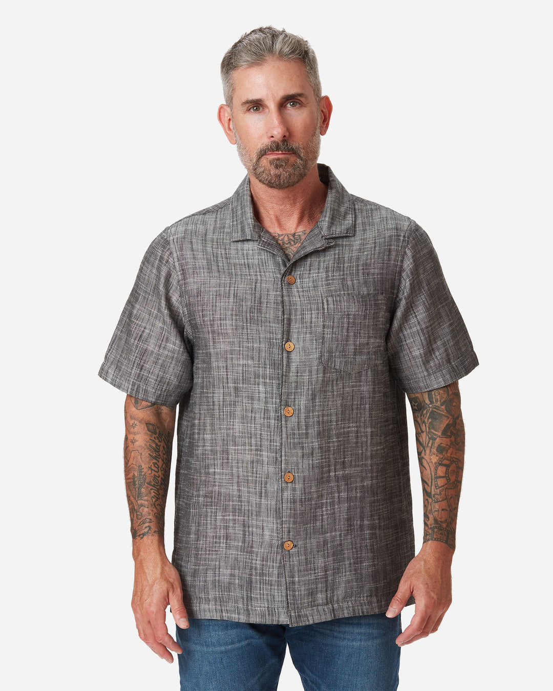 Model with directly frontward posture Ace Rivington "Black" Double gauze soft-textured cotton fabric camp collar shirt with coconut buttons and left-breast pocket and a pair of Ace Rivington dark vintage blue denim jeans