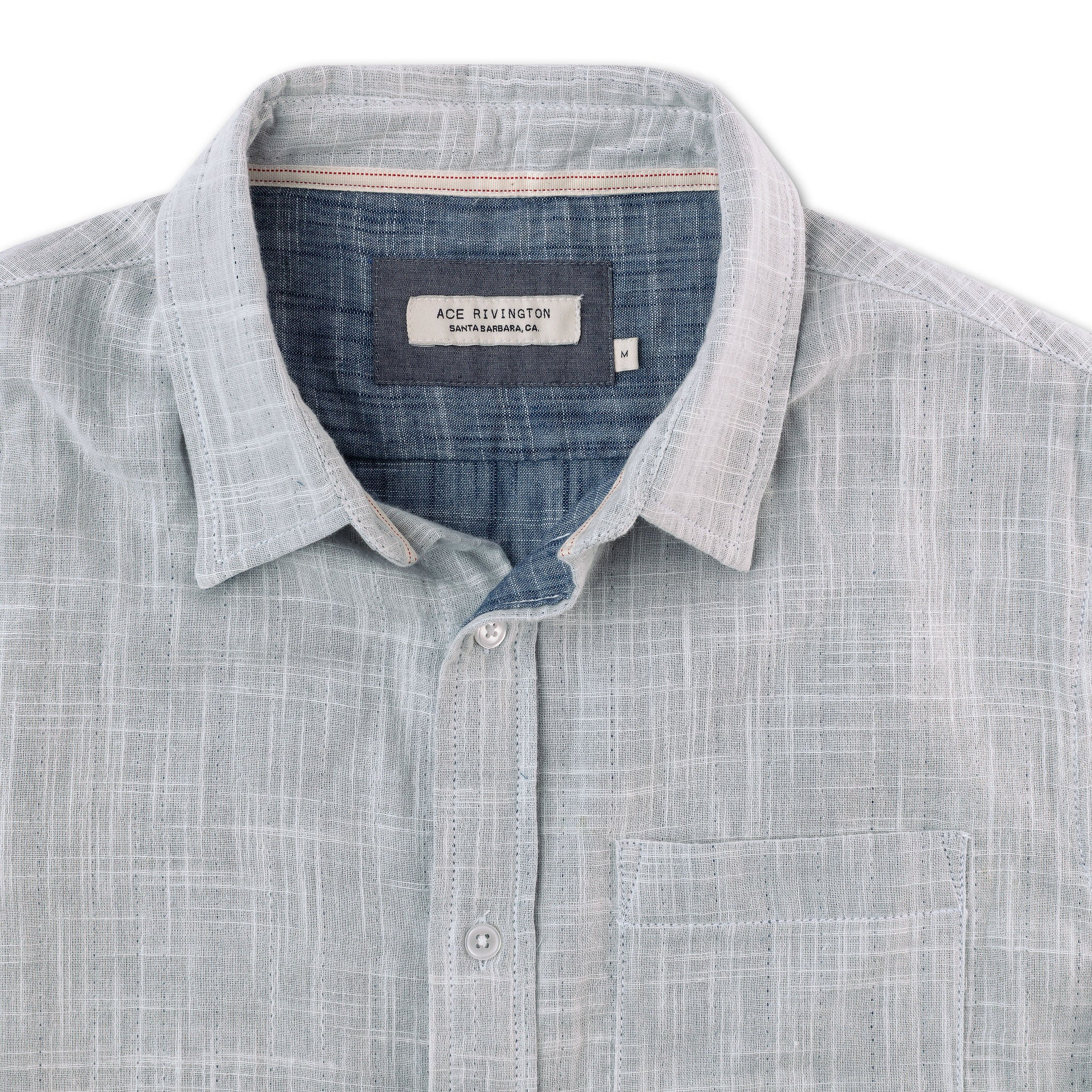close up of collar, buttons, pocket, and tag on front of men's double gauze short sleeve button up shirt with a single pocket and indigo slub cotton interior