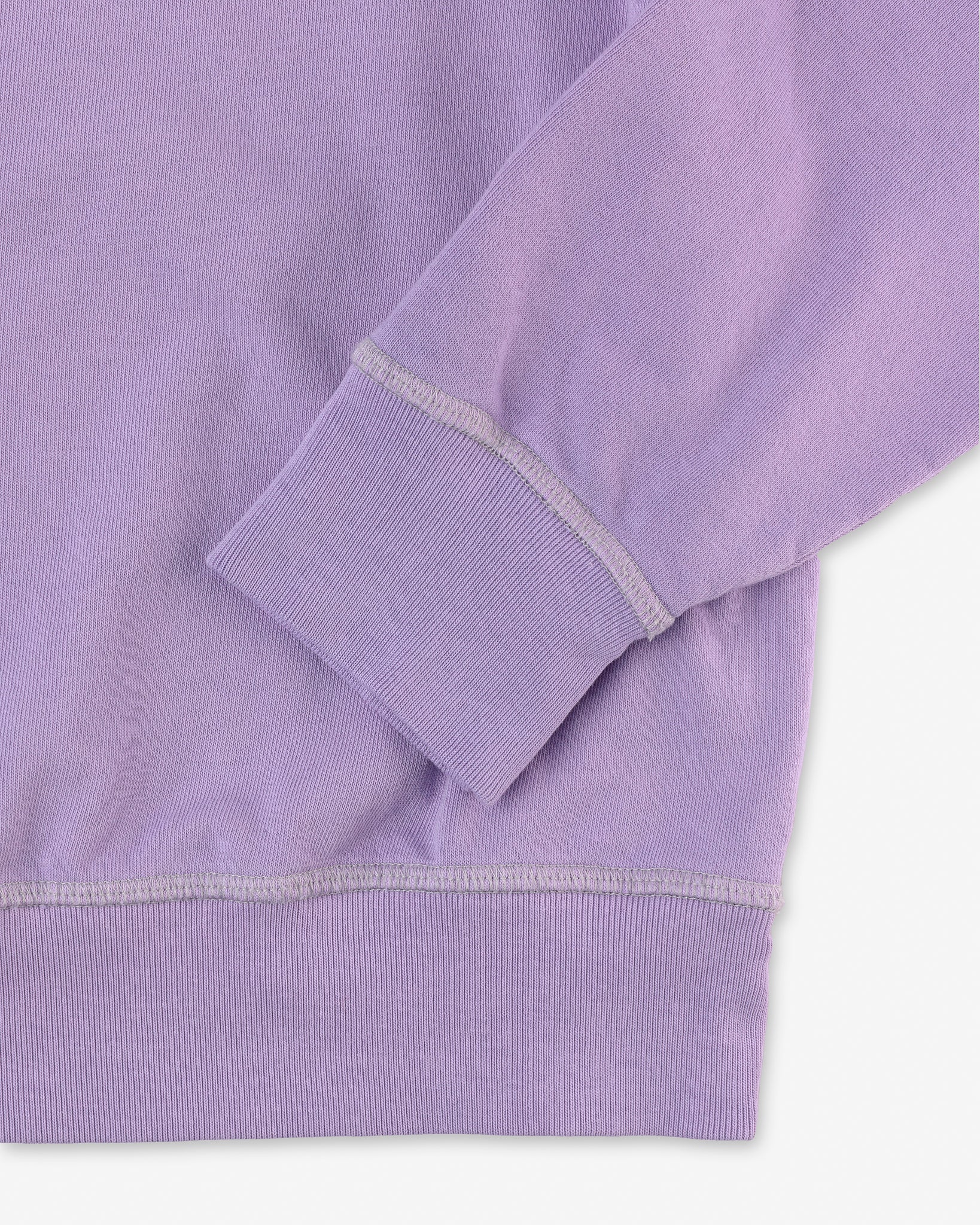 close up of hem and cuff on front of men's digital lavender purple long sleeve sweatshirt made with organic cotton