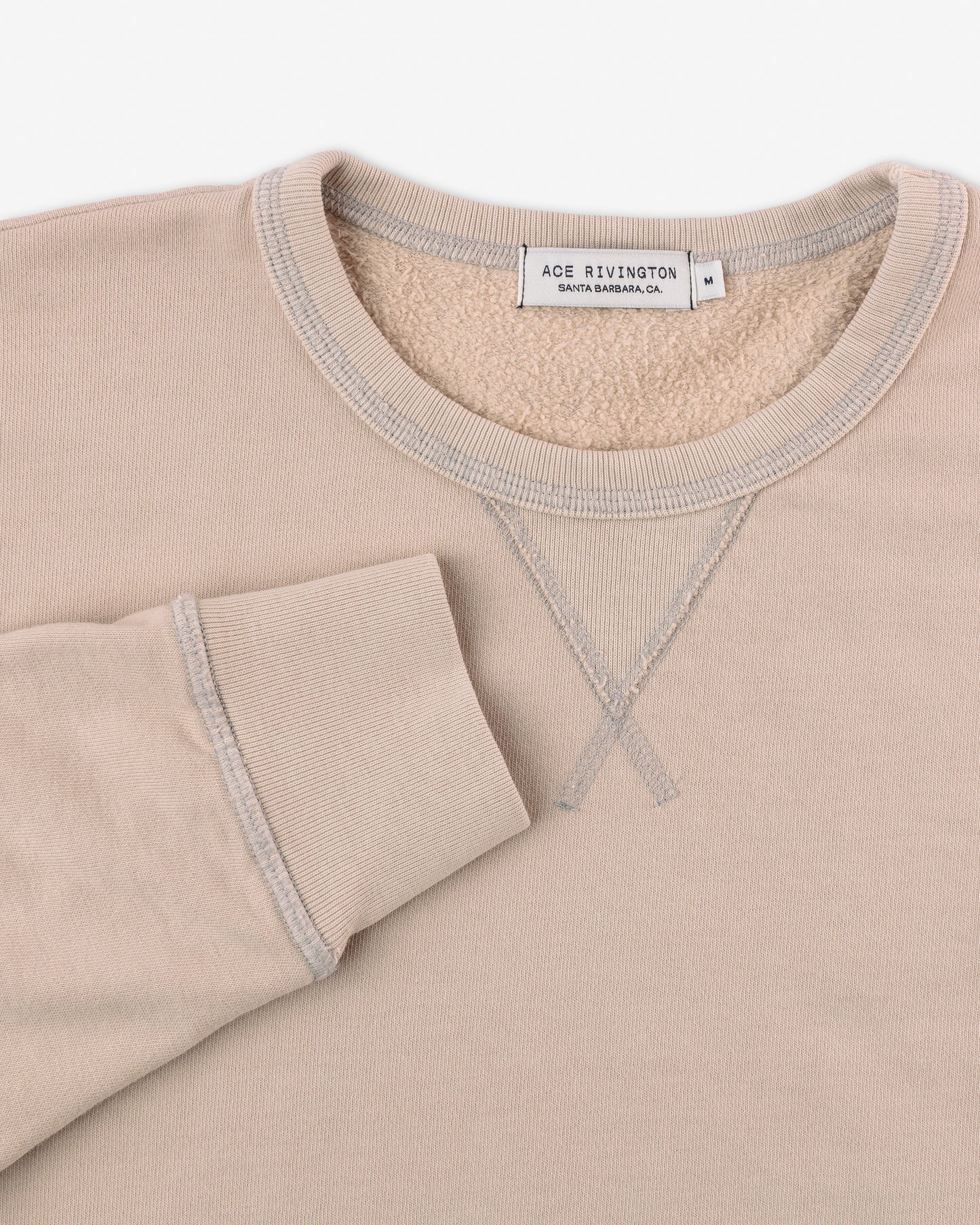 close up of cuff and collar on front of men's light beige khaki long sleeve sweatshirt made with organic cotton