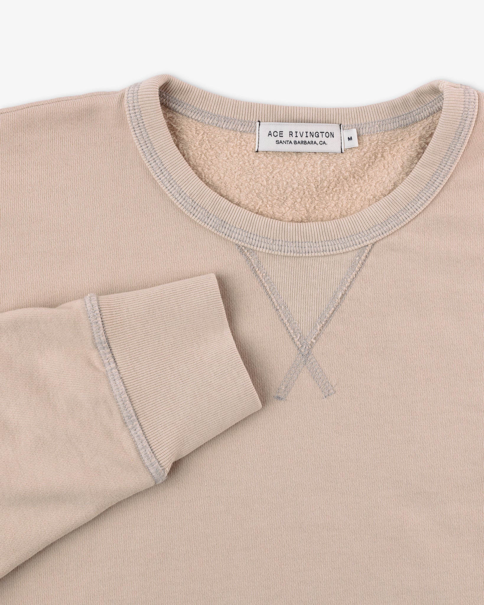 right sleeve set near collar of organic cotton sweatshirt in light khaki