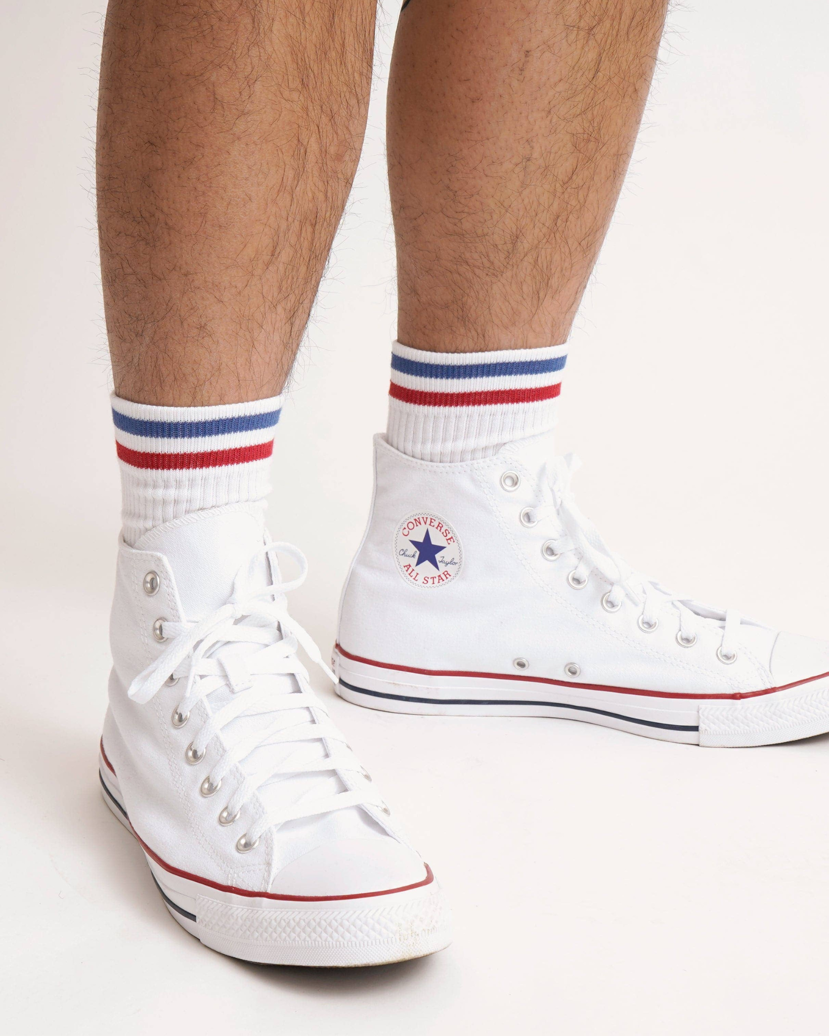 Kennedy Luxe Athletic Socks - White/Blue/Red worn mid-calf with white high-top shoes, shown in a studio setting from a frontal leg view.
