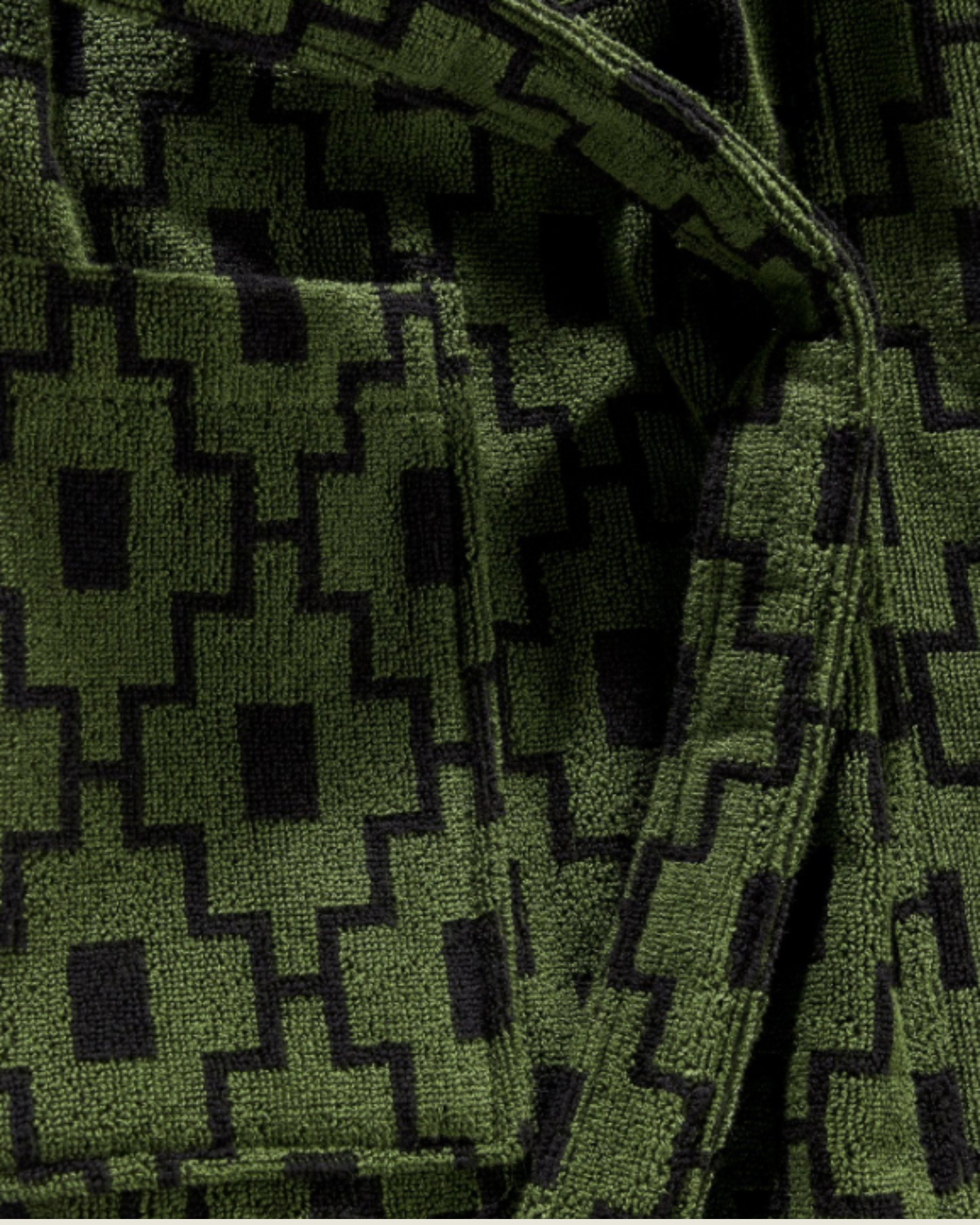 OAS Terry - Robe - Machu Pichu close-up of the terry cloth fabric showing intricate texture and bold geometric pattern in black on green, emphasizing plush detailing and stitching.