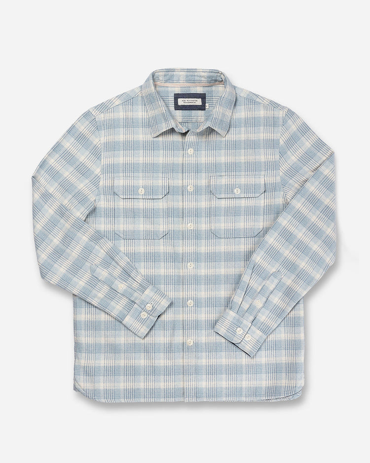 Front of full-view flat lay with over-folded arms of Ace Rivington soft-brushed flannel shirt with pearl buttons and off-white and light blue and black checkered grid plaid design with pearl buttons and double breast pockets with buttoned enclosure 