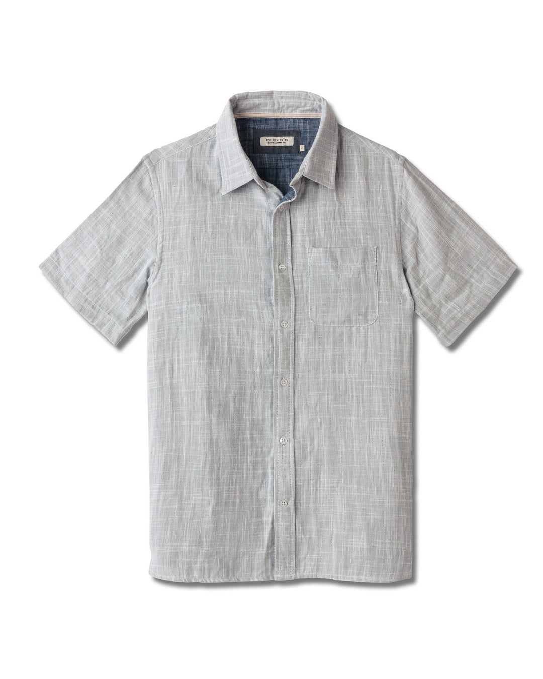 Front of full-view flat lay of Ace Rivington collared grey short-sleeved double gauze soft-textured cotton shirt with indigo blue interior, pearl buttons, and left-breast pocket