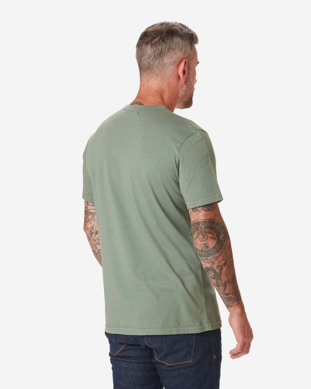 back of model facing away with a rightward gaze wearing  Ace Rivington seafoam "sage" light green long staple cotton super soft supima cotton shirt