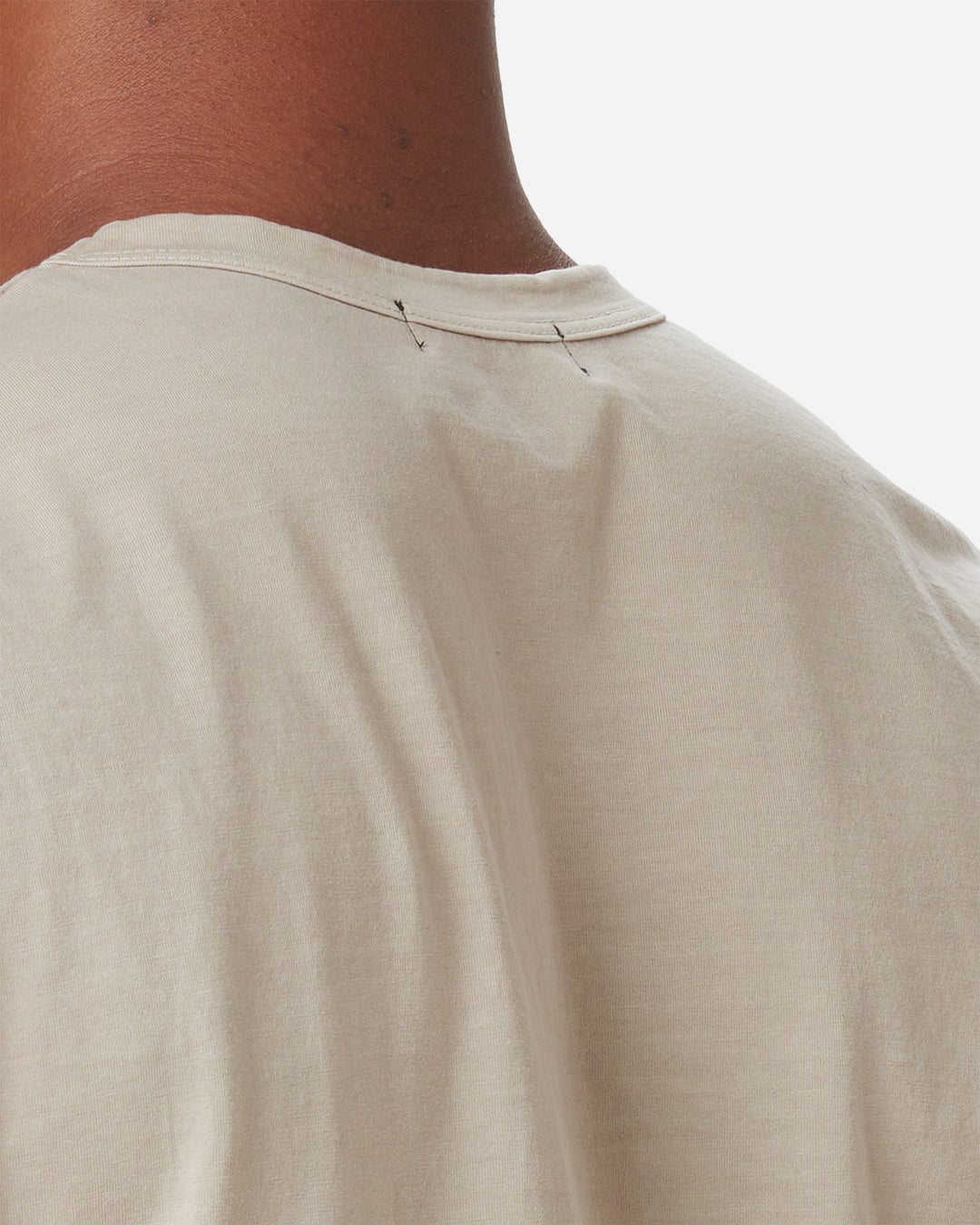 close up of back of model's neck wearing Ace Rivington long staple light beige sand coloredsuper soft short-sleeved cotton shirt 