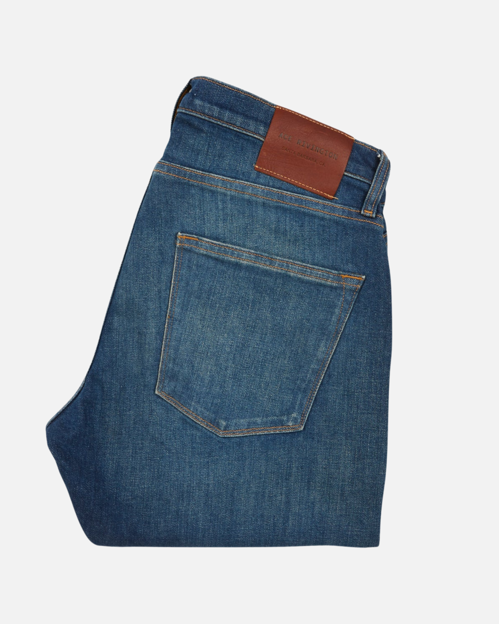 back of folded pair of high quality slim cut men's green hue blue jeans with slight wear