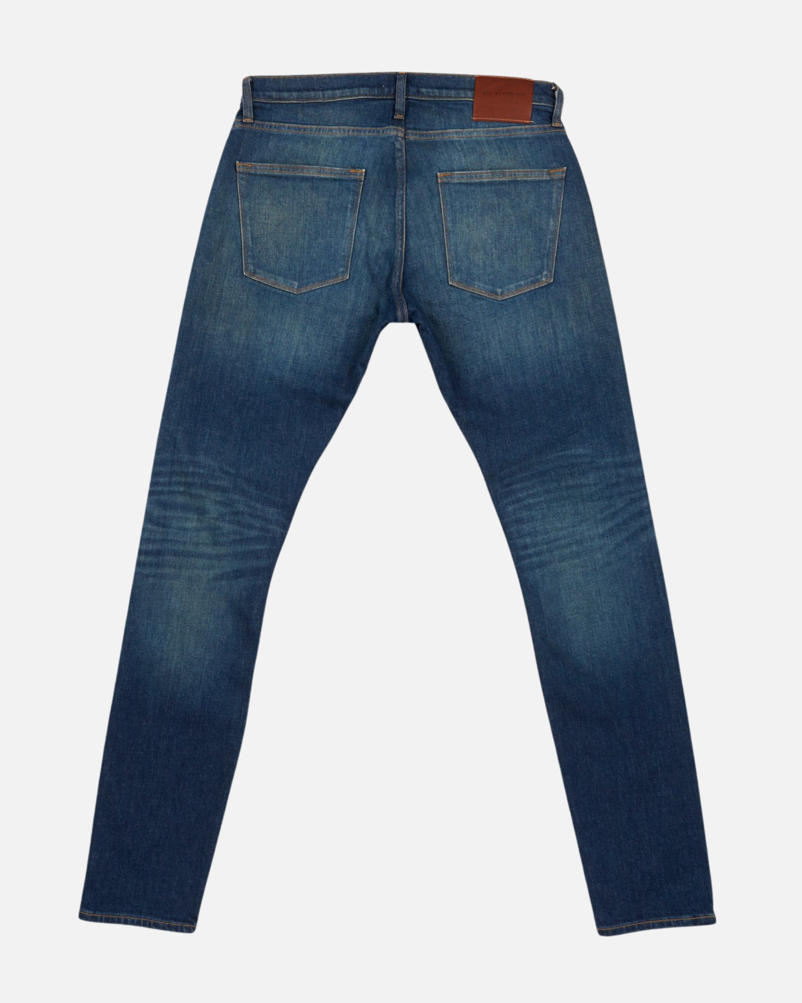 back of fully extended pair of high quality slim cut men's green hue blue jeans with slight wear