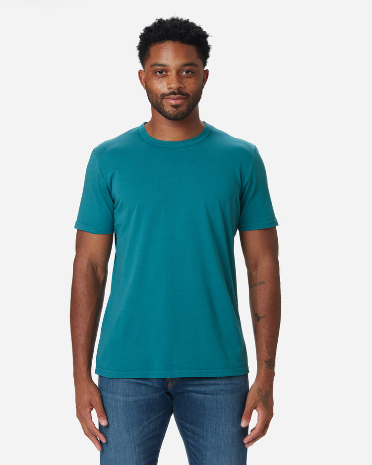 Model facing directly forward wearing Ace Rivington light blue teal long staple cotton super soft supima cotton shirt