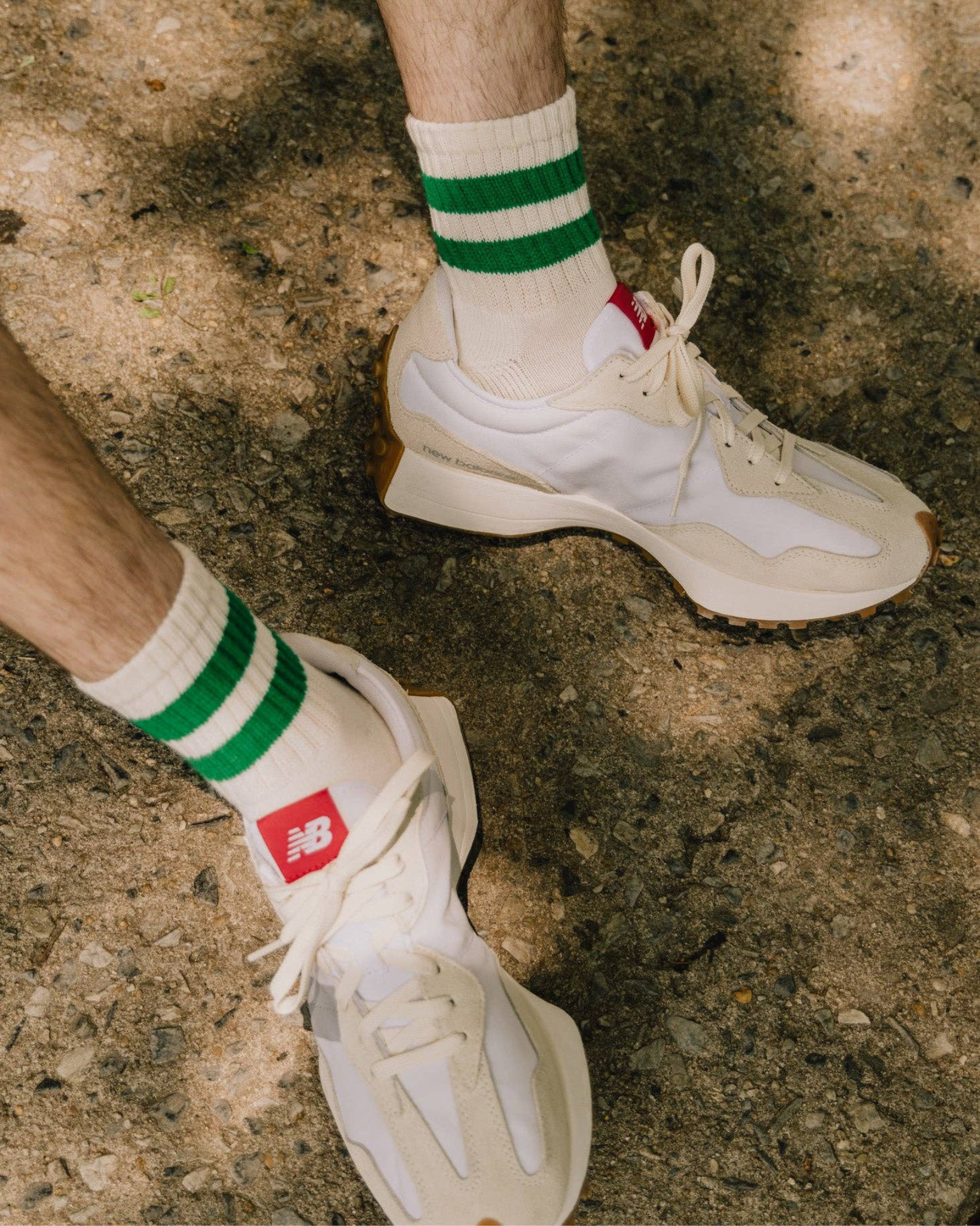 The Mono Stripe Quarter Crew – Green: Outdoor shot of The Mono Stripe Quarter Crew in green stripes, styled with white and cream New Balance shoes on gravel path.