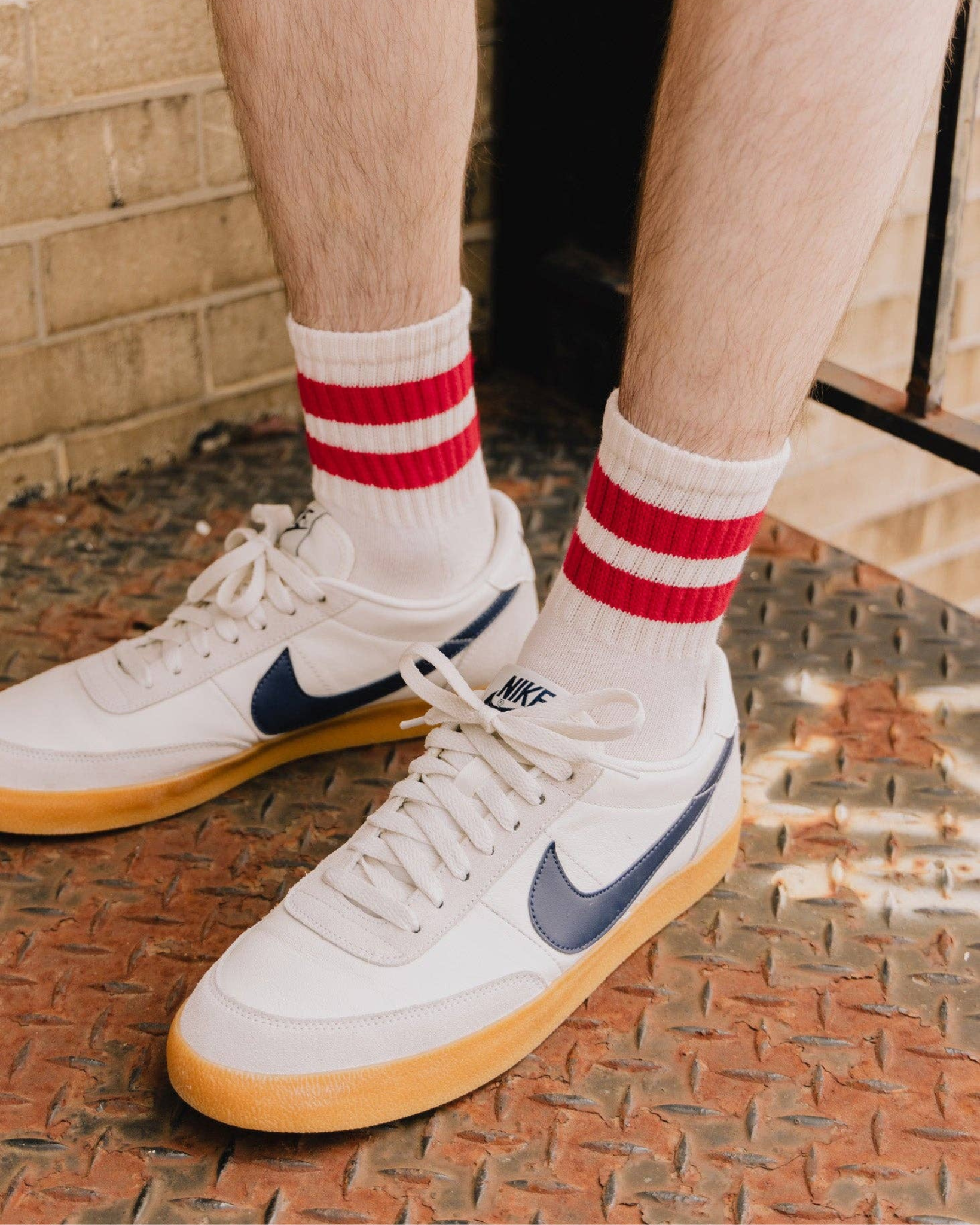 The Mono Stripe Quarter Crew – Red: Urban scene featuring The Mono Stripe Quarter Crew with bold red stripes, paired with classic white and navy Nike shoes.