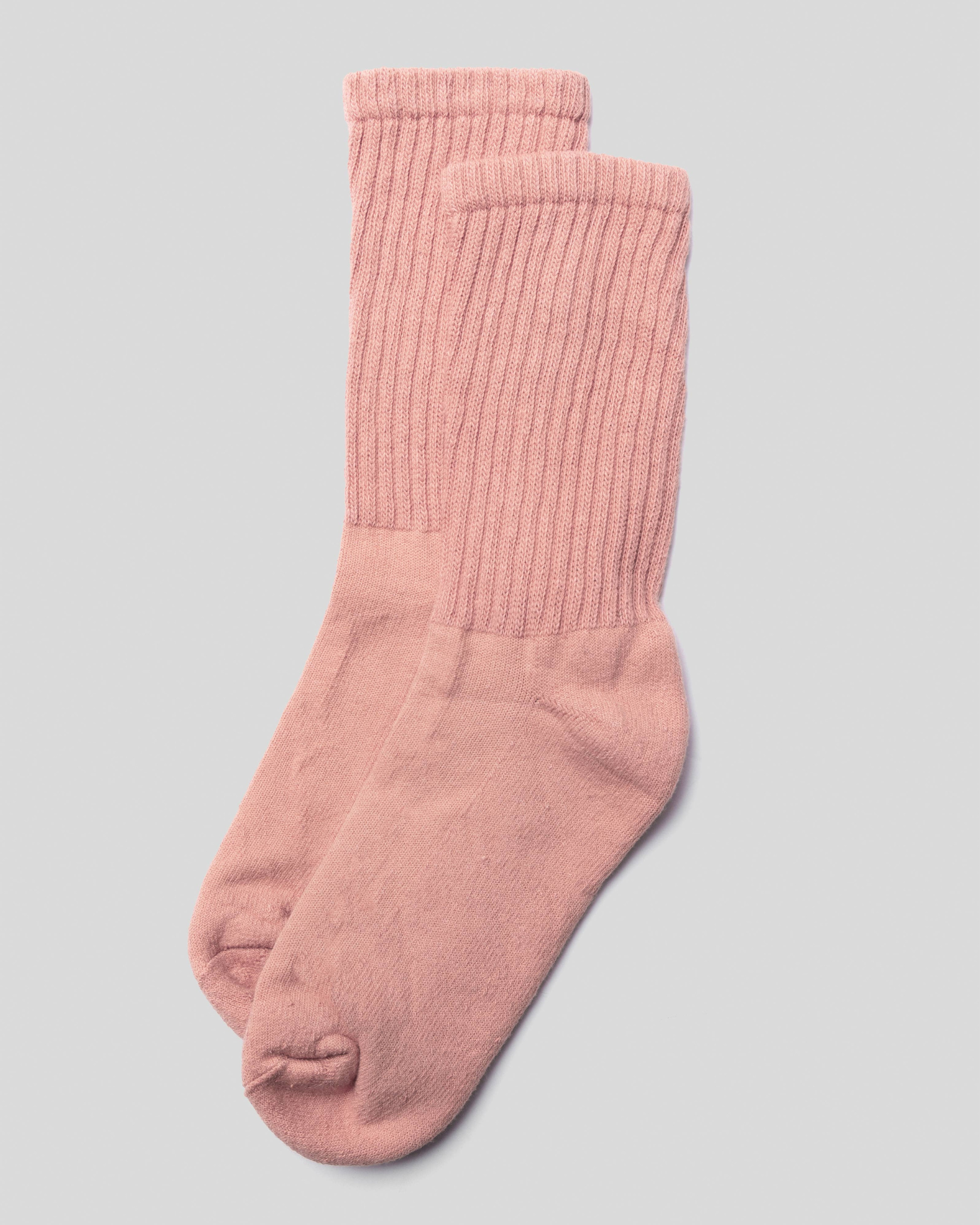 The Solids - Pink in a top-down view with a ribbed design and soft pink hue on a light grey background.