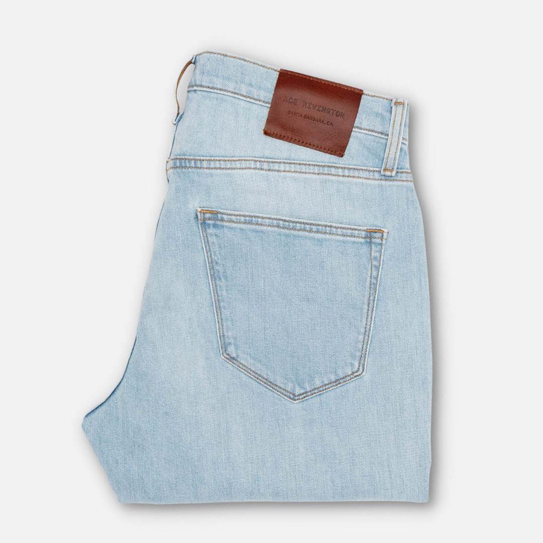 back of folded pair of  Ace Rivington super light blue denim jeans with antique nickel detailing