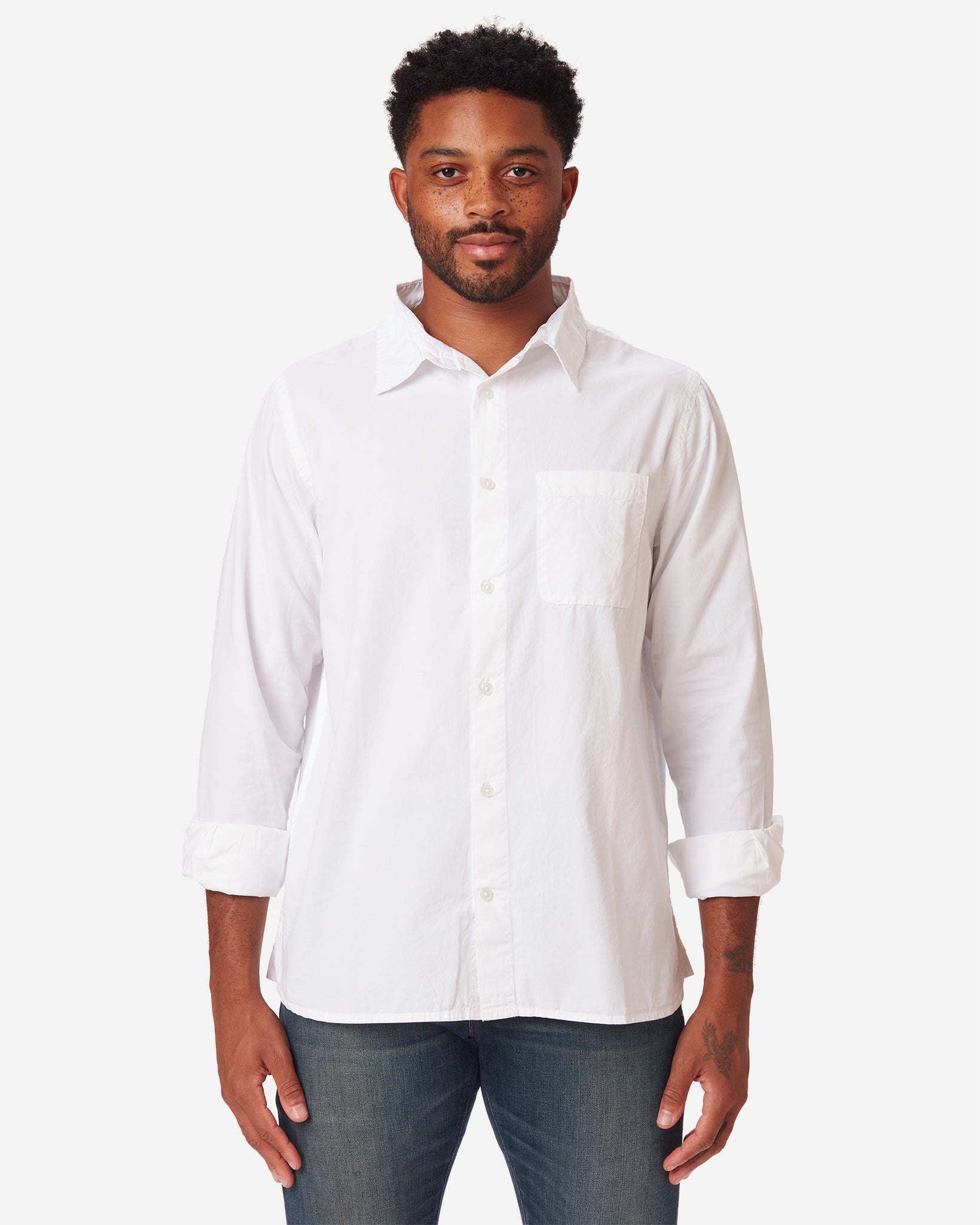 model facing directly forward wearing men's white long sleeve tailored poplin shirt with color matched buttons and a single pocket in standard height option